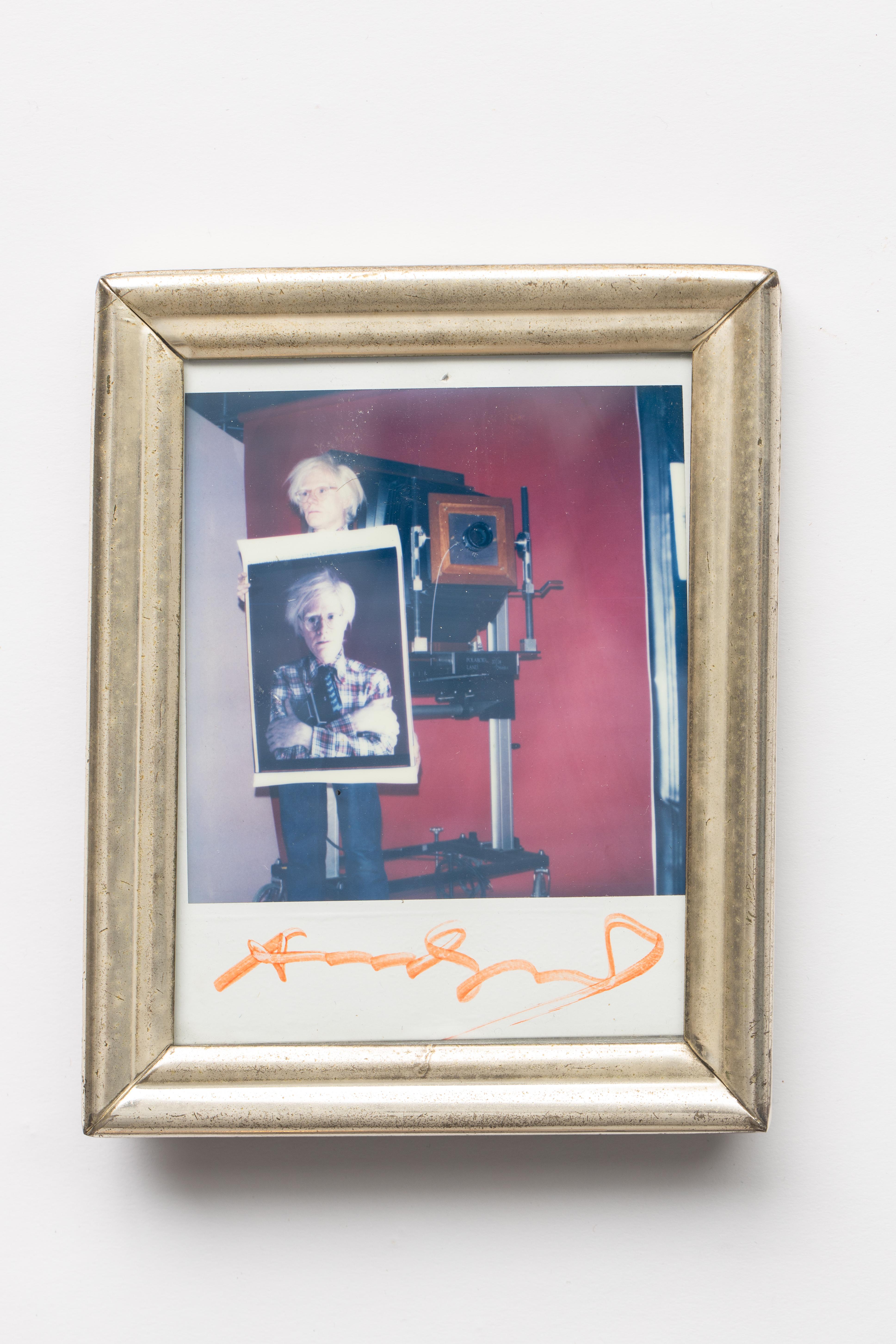 Bill Ray (1936-2020) polaroid photo of Andy Warhol holding a self-polaroid with 20 x 24 polaroid camera in background, circa 1980. The photo Andy is holding was minutes old, shot by Bill Ray for New York magazine with the 20 x 24 camera in