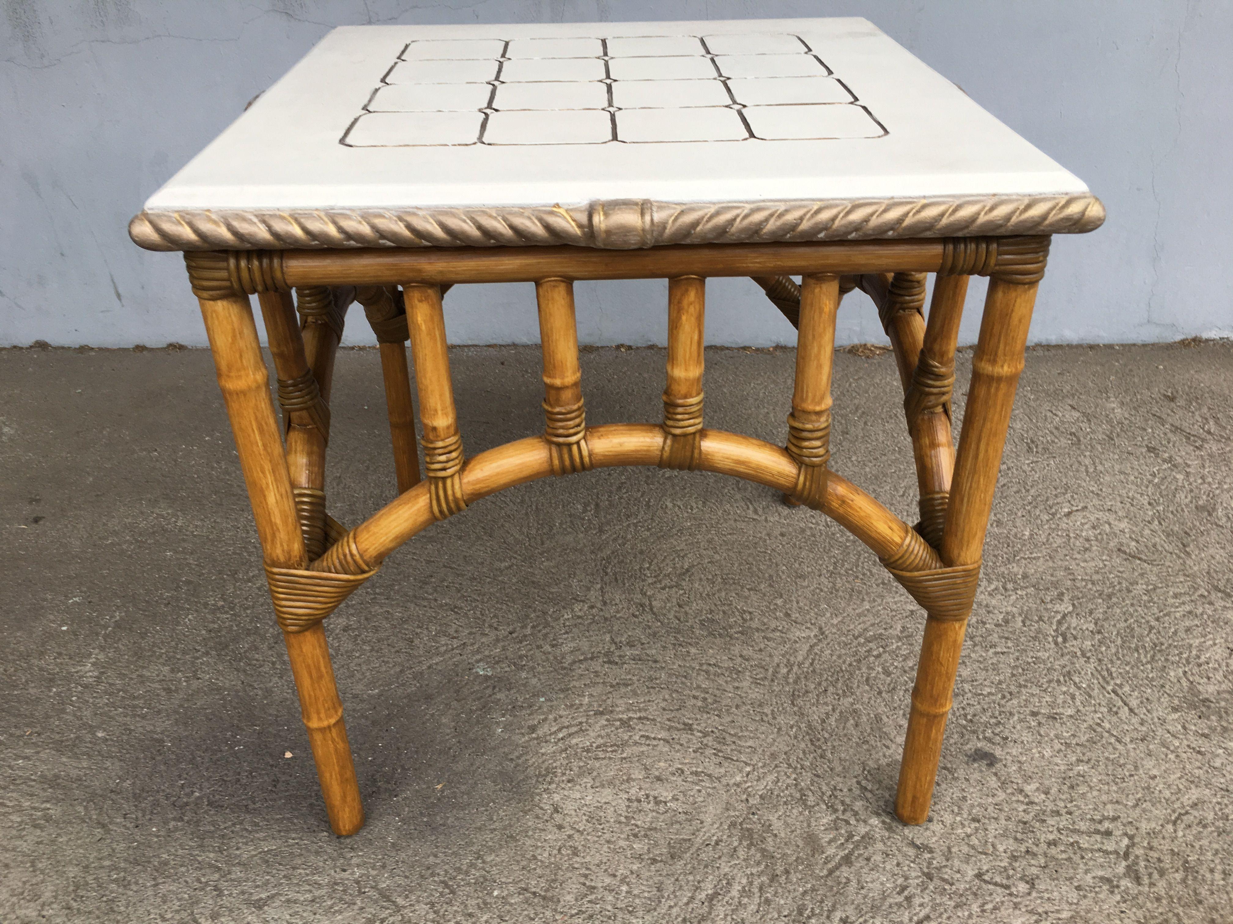Vintage pole rattan center coffee table featuring an arched base with square patterned solid resin top, circa 1980 restored to new for you. All rattan, bamboo and wicker furniture has been painstakingly refurbished to the highest standards with the
