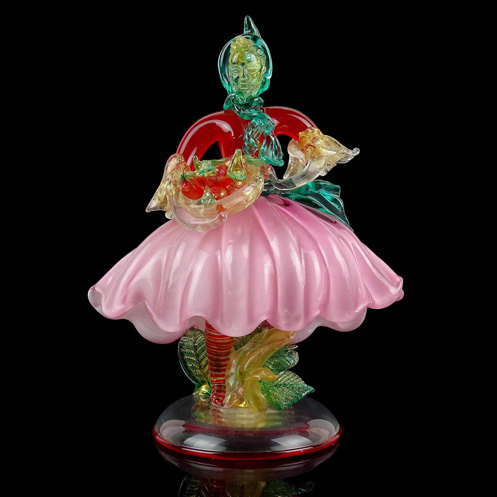 Beautiful and rare, vintage Murano hand blown red, pink, green and gold flecks Italian art glass woman figurine / sculpture. Documented to designer Flavio Poli for Seguso Vetri d'Arte, circa 1954. Model number 6938, and published. The figure is on
