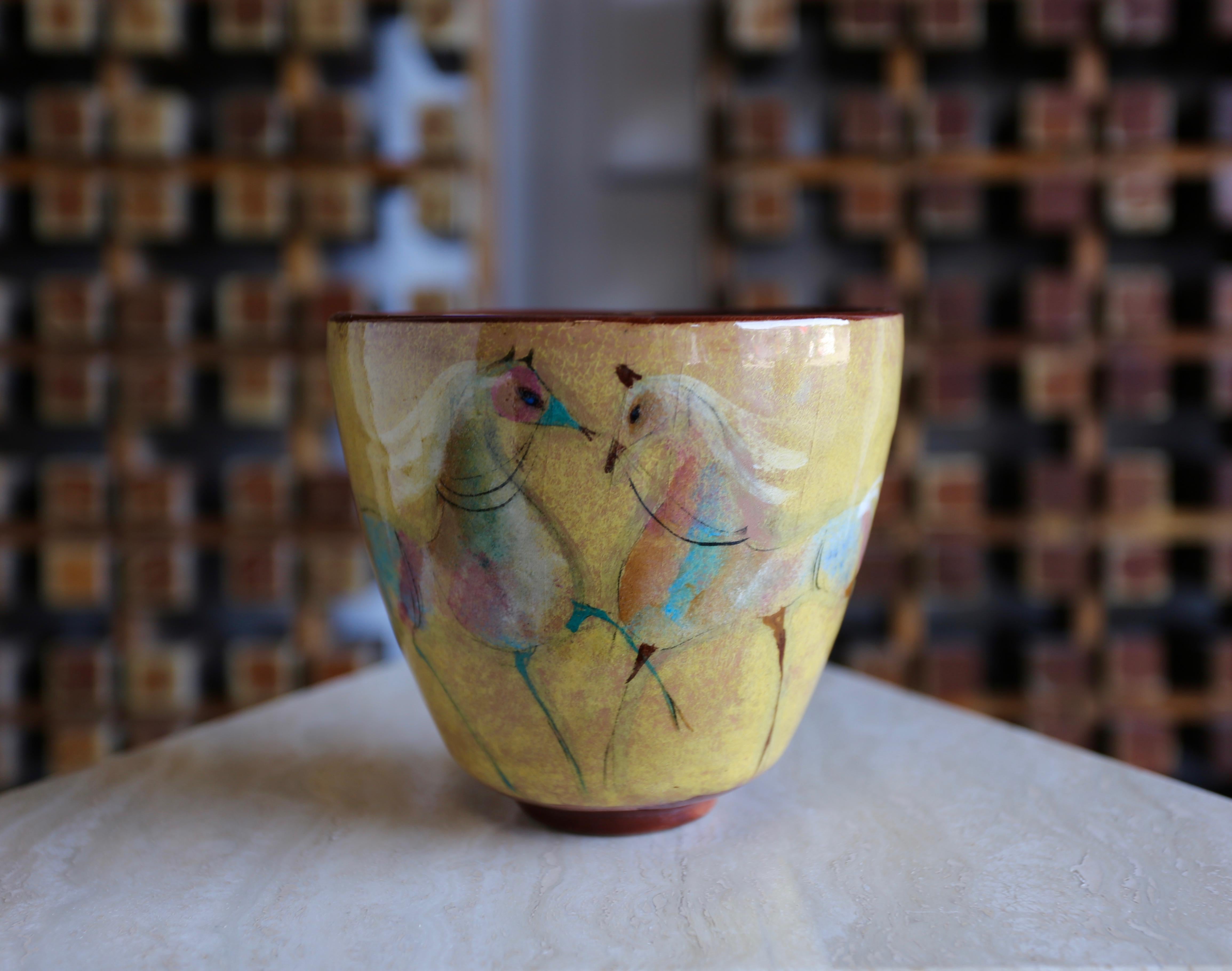 A signed Polia Pillin ceramic bowl depicting horses.