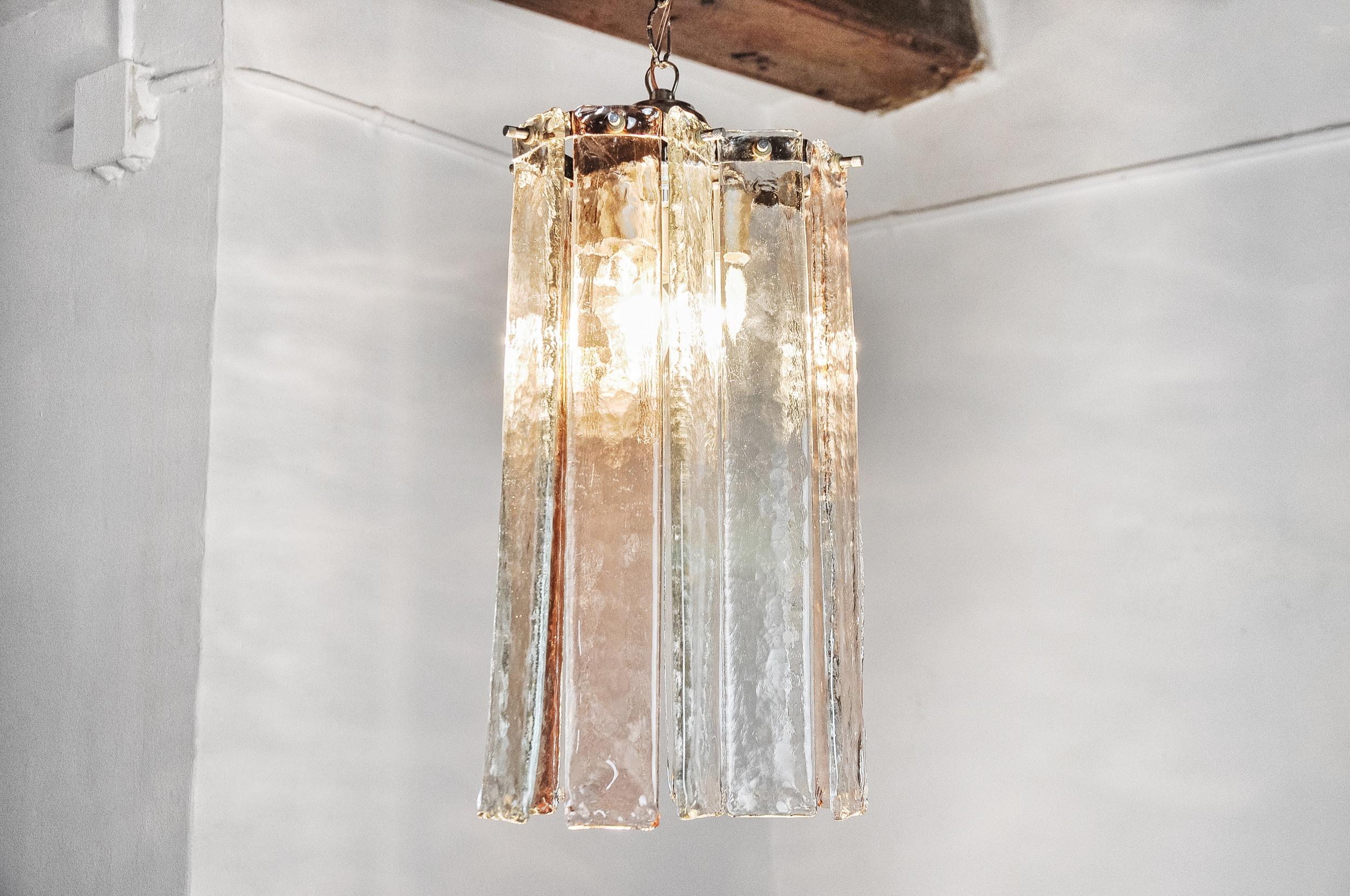 Superb and rare Poliarte chandelier by Albano Poli, designed and produced in Italy, in the 1970s. This chandelier is composed of thick pink and transparent glass rods, frosted, suspended from a silver metal structure. The glass work was done in