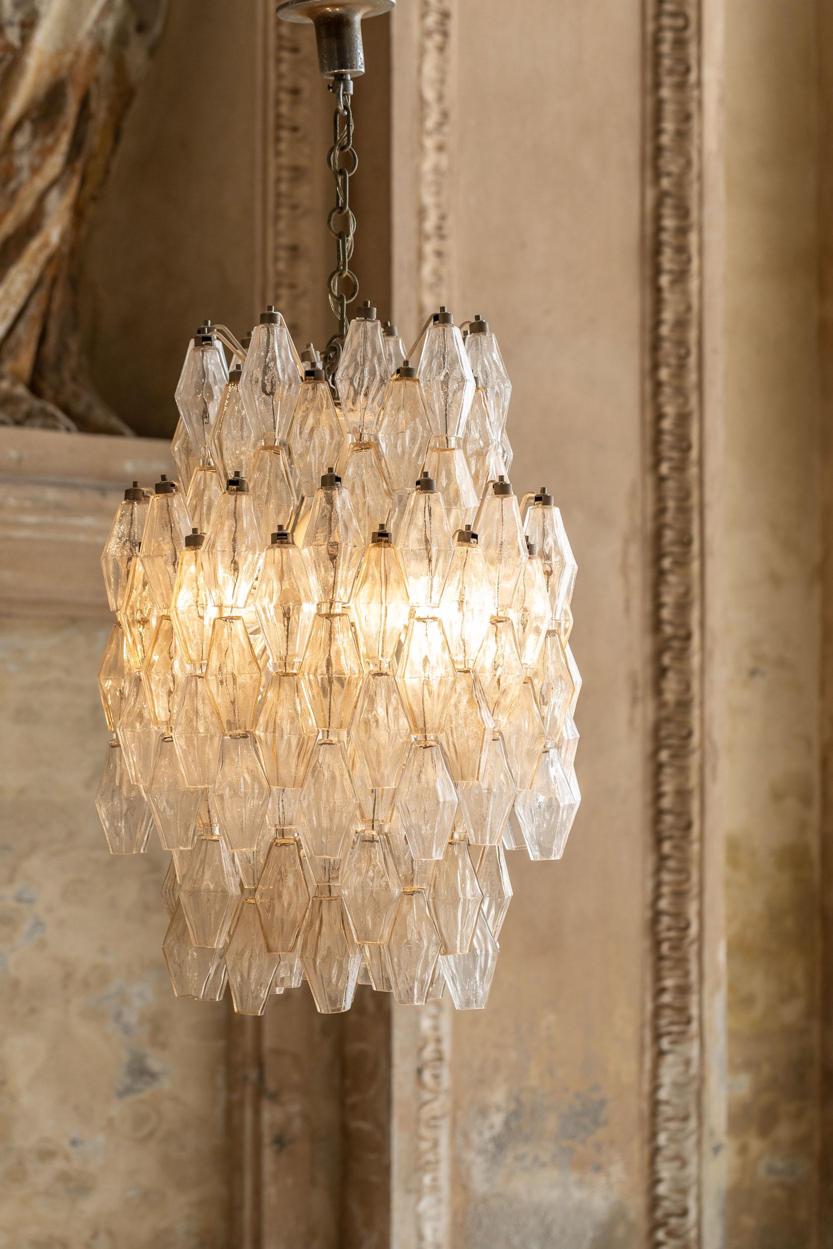 Very elegant poliedri chandelier attributed to Carlo Scarpa for Venini in hand blown Murano glass in clear tones. 
The metal structure holds an high number of poliedri and the chandelier have a considerable dimension. 

One chandelier is shown in