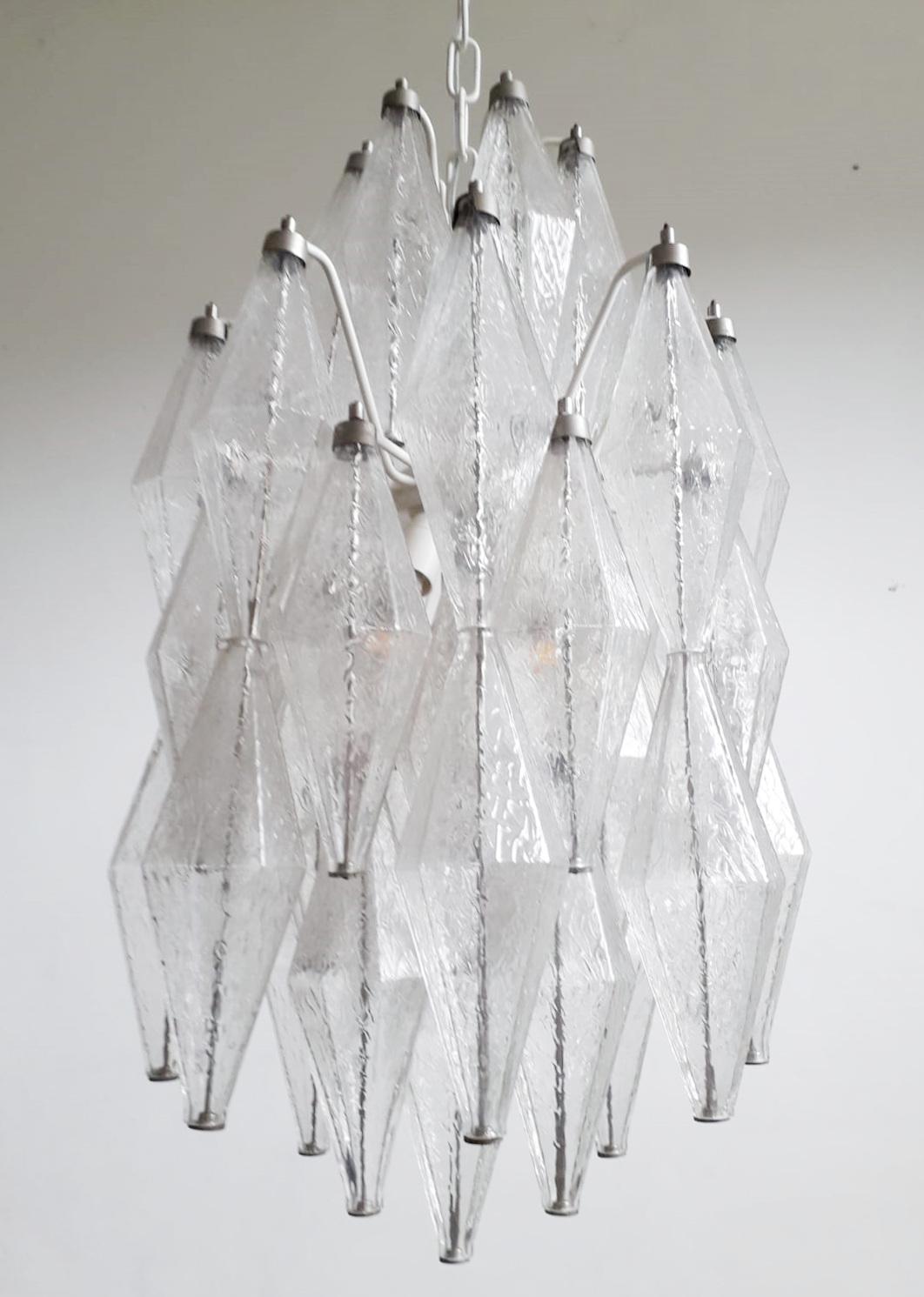 Vintage Italian chandelier with clear hand blown polyhedron/polyhedral shaped Murano glasses suspended on white metal frame / Made in Italy by Venini, circa 1950s
Measures: diameter 15 inches, chandelier height 23.5 inches, total height 42 inches