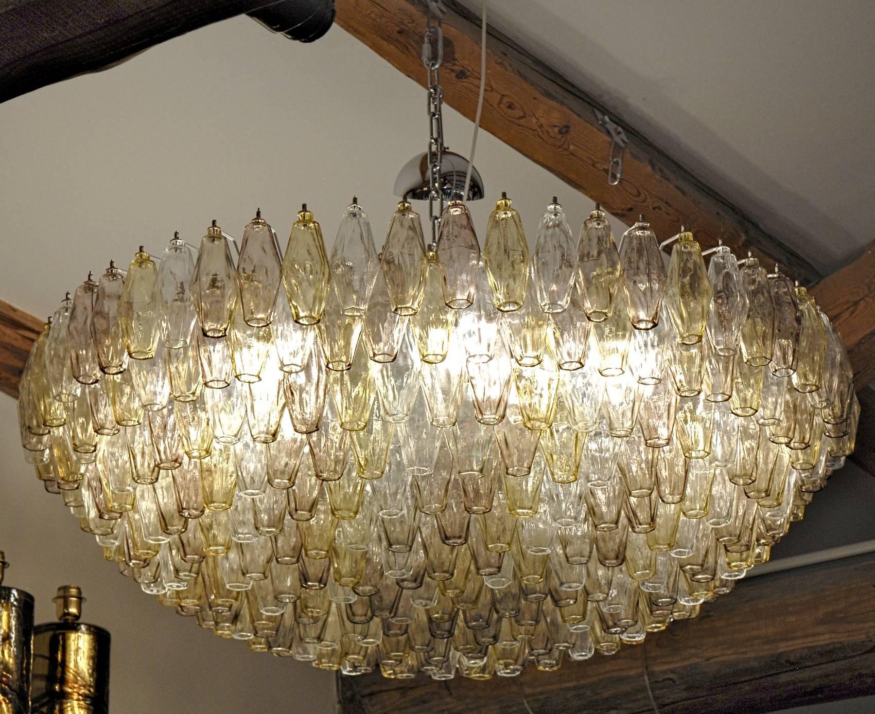 Very large and elegant midcentury chandelier. For large a large hall, ballroom or public spaces. Would be stunning in a large midcentury living room or an eclectic home. The size requires a large room. This triedri chandelier carries a classic