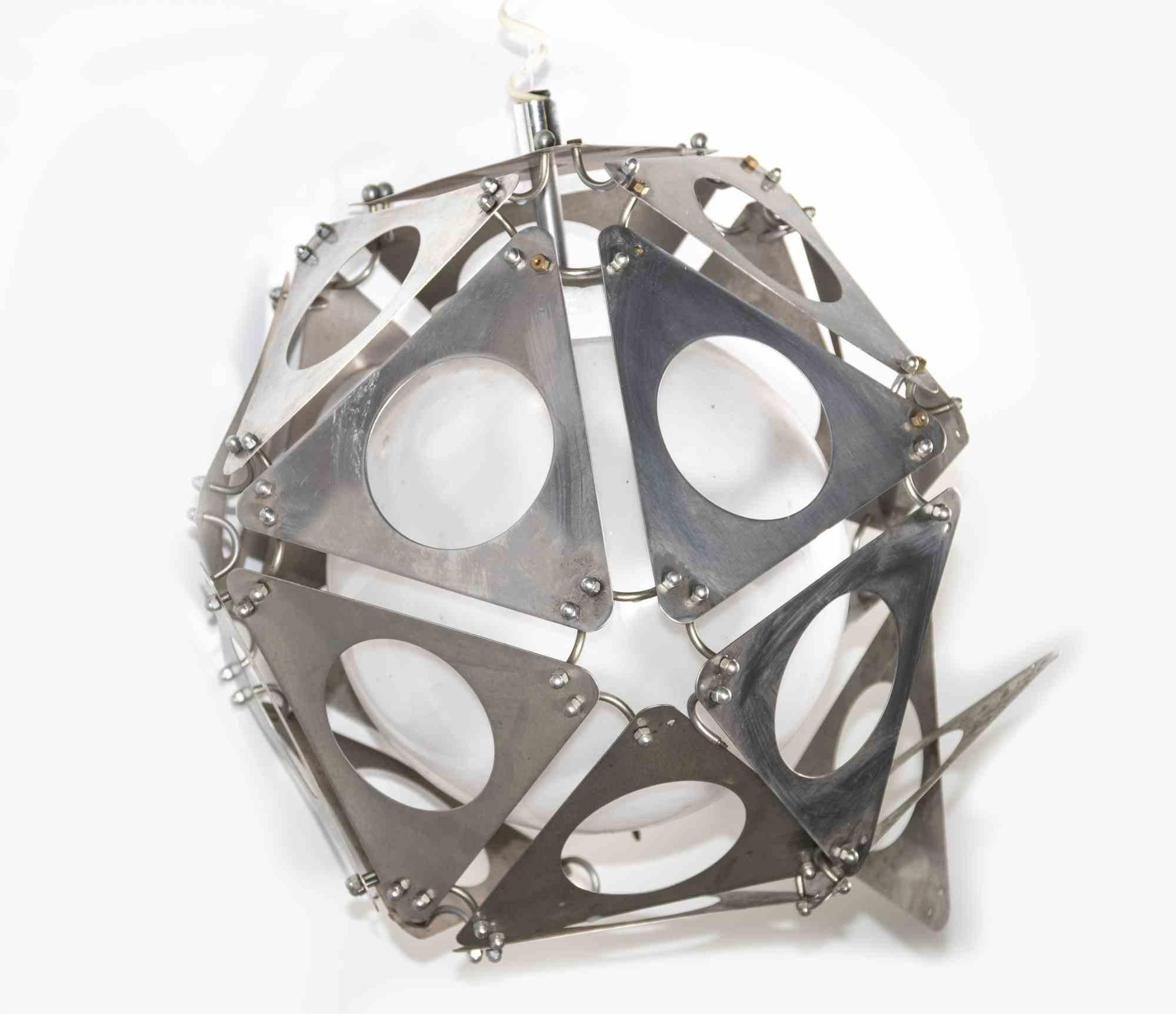 Poliedric Lamp is a design chandelier lamp realized in the 1970s.

A vintage lamp with a metal geometric structure composed by a triangular shapes with holes and the lamp in the center.

Mint conditions.

Collect a unique design lamp. 