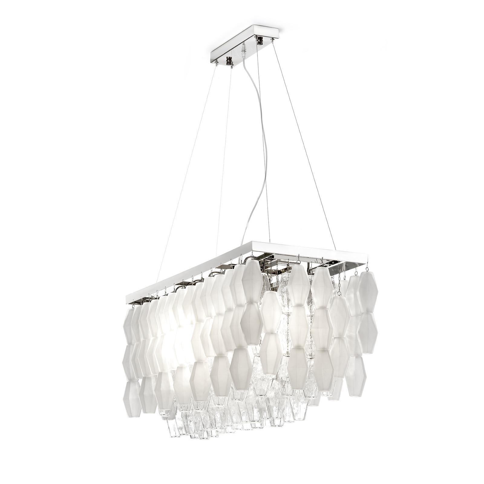 This stunning ceiling lamp is part of the Poliedro collection and is aptly named after a series of glass polyhedrons that hang from a metal structure with a polished nickel finish. The rectangular structure supports 12 E14 40W bulbs, whose light