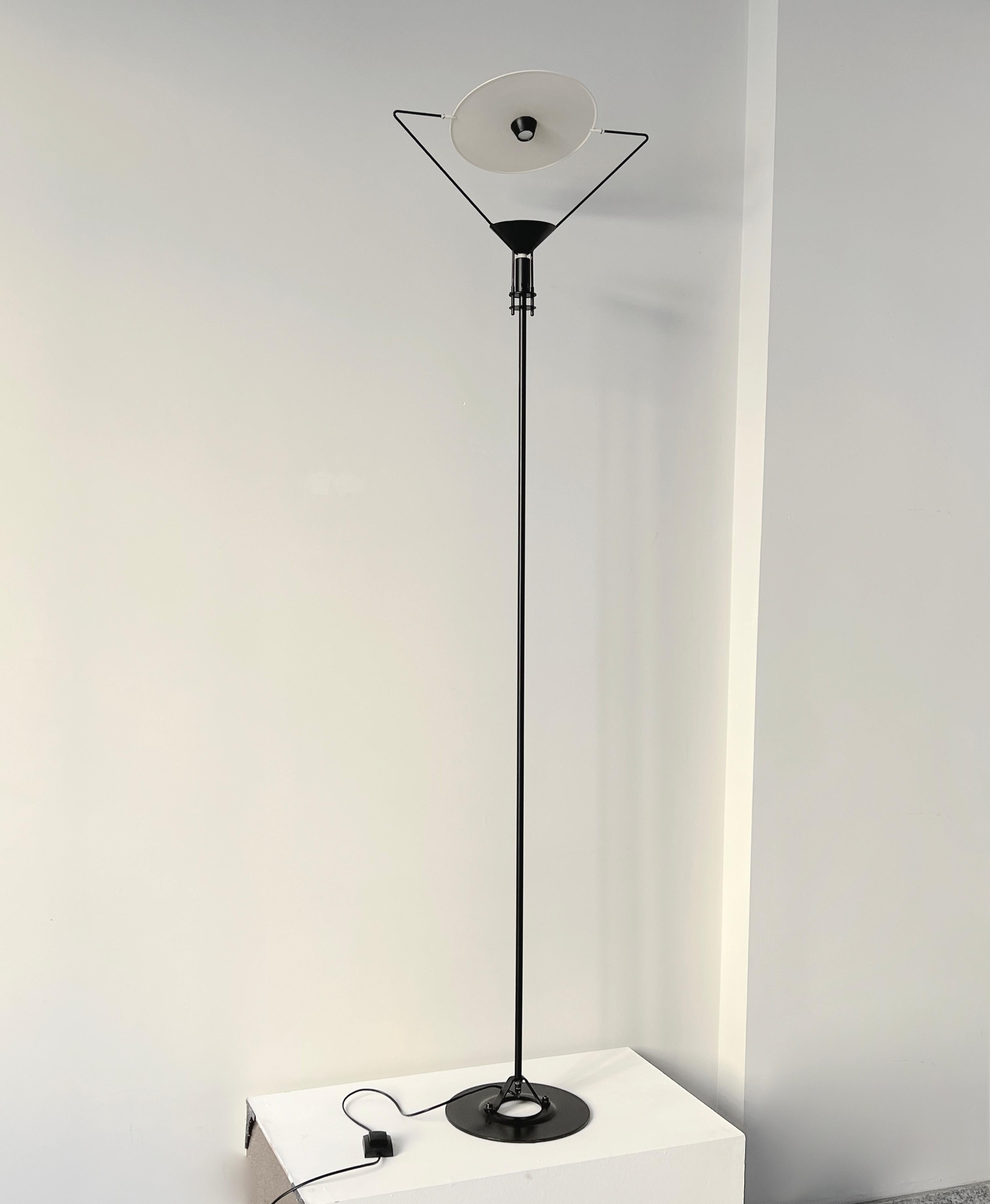 During the 1980s, Artemide produced an Italian postmodern floor lamp crafted by the renowned designer Carlo Forcolino. This lamp features a sleek black lacquered metal body and a strikingly sculptural round diffuser. Notably, the lens is elegantly