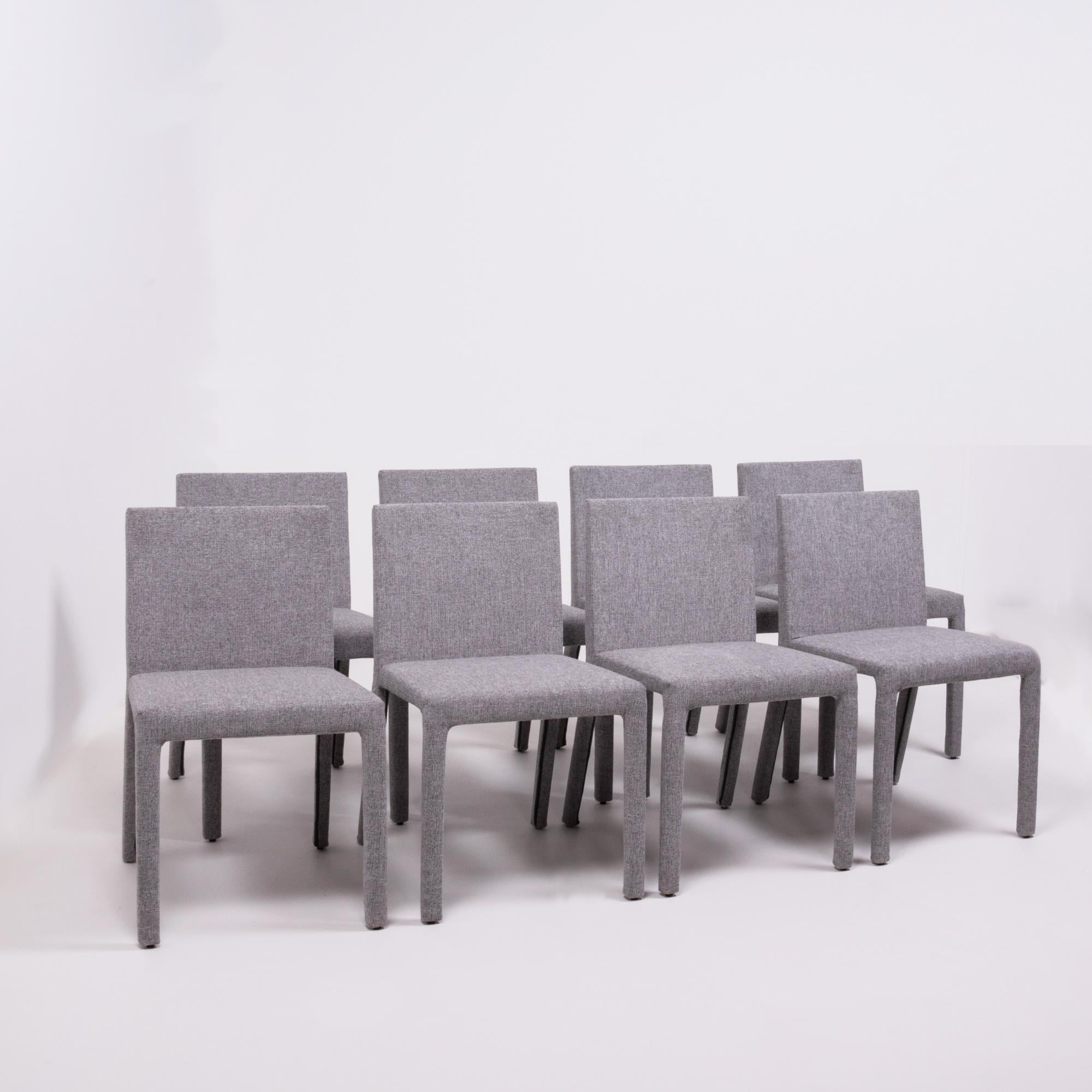 Designed by Carlo Colombo for Poliform in 2004, the Fly Tre chair is both sleek and sophisticated.
Newly and fully reupholstered in grey fabric, this set of eight dining chairs features comfortable padded seats and removable covers.
  