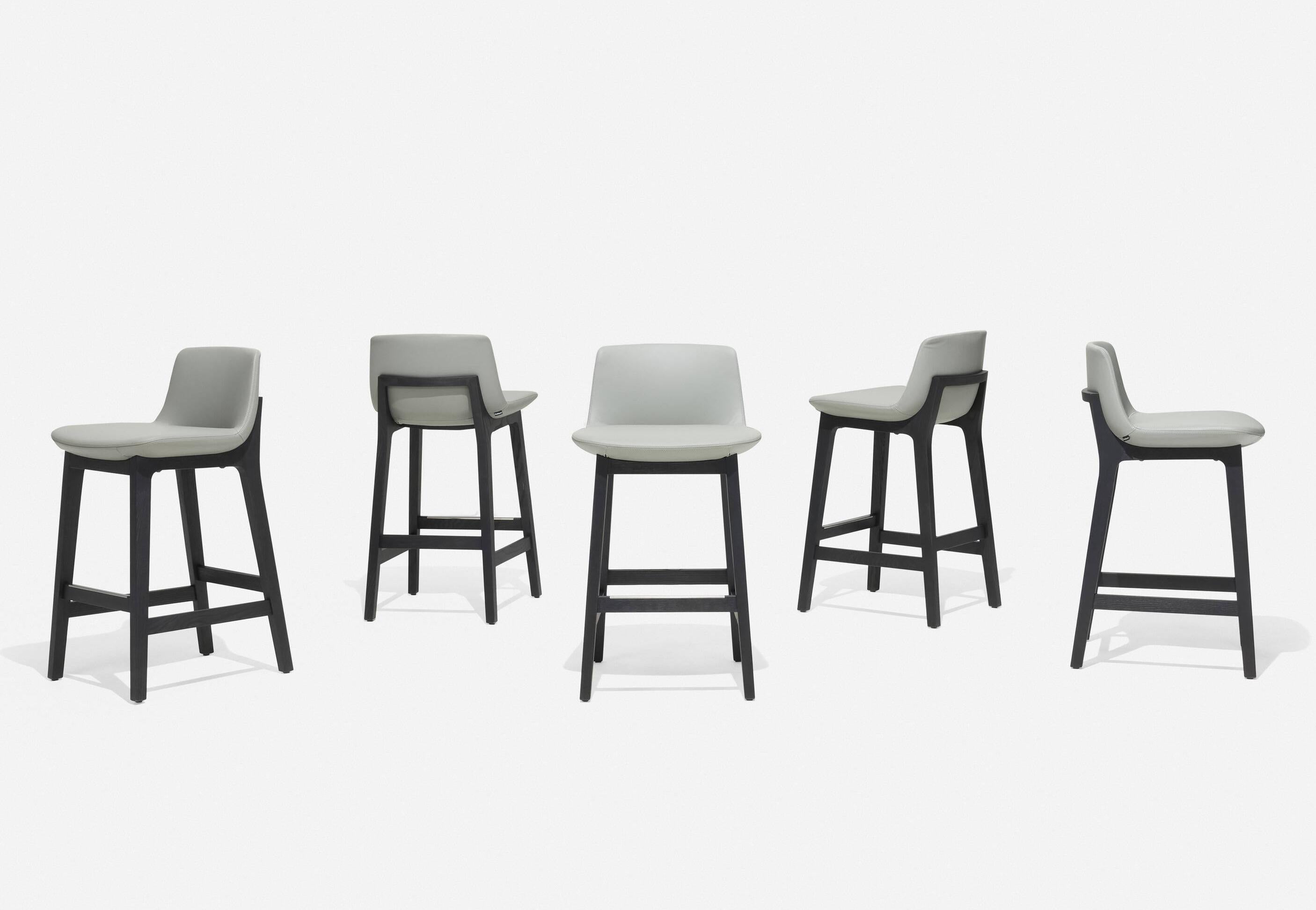Designed by French Architect Jean-Marie Massaud (1966-) for Poliform designed in 2011, These Ventura counter stools are new production from 2020s stocks in storage and of unused near mint condition. Constructed in stained black elm wood, Gary high