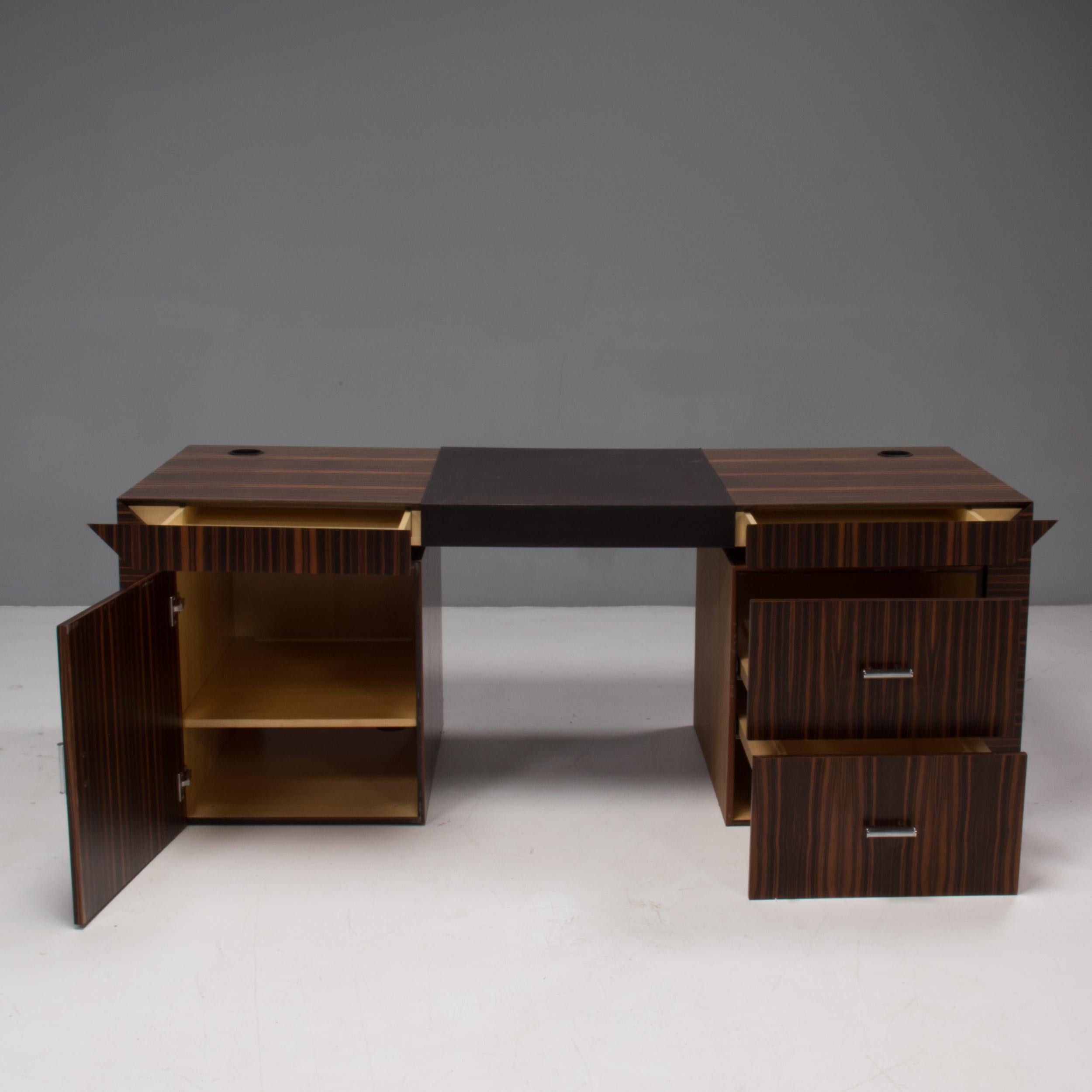 Beautifully constructed, this vintage Poliform desk is a timeless piece of Italian design.

Constructed from wood, the desk has an angular frame, enhanced by the striped wood veneer which complements the linear shape, finished with contrasting
