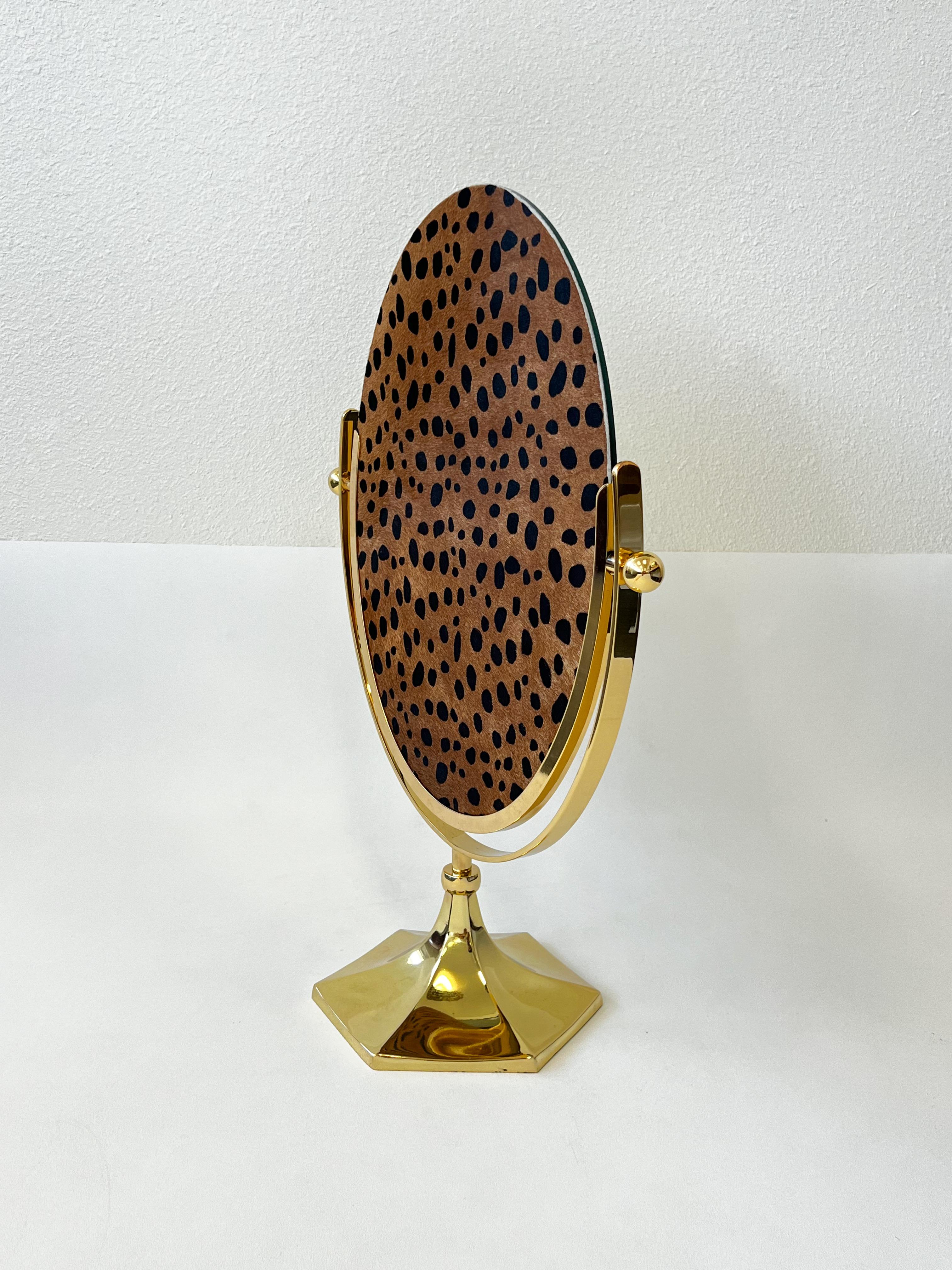 1970’s Large polish brass and faux Cheetah hide with hair vanity mirror by American renowned designer Charles Hollis Jones. 
In beautiful vintage condition with minor age spots. New mirror and backing. 

Measurements: 17.5” Wide, 8” Deep, 24.25”