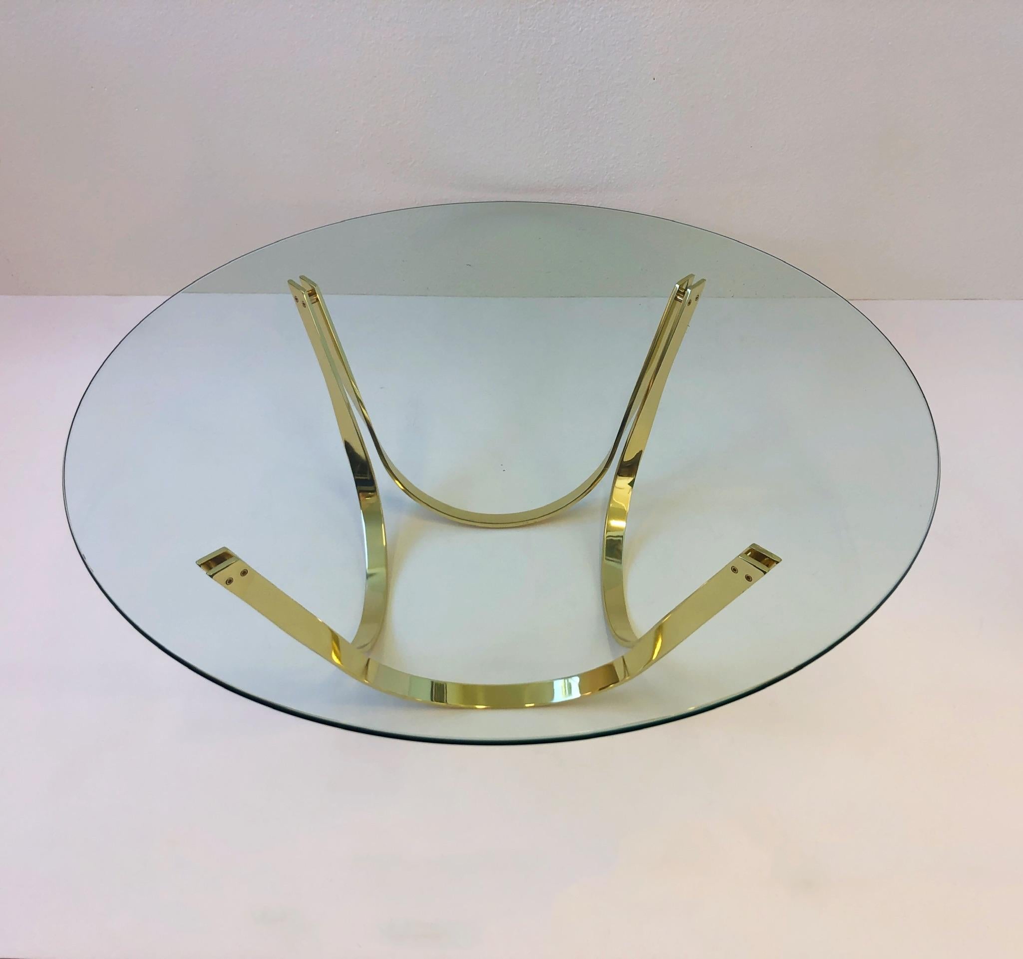 A spectacular polish brass and glass cocktail table design in the 1970s by Tri-Mark.
The table has a new 1/2” thick 48” diameter glass top. The base is in great condition with some minor wear (see detail photos).
Dimensions: 17.25” high, 48”