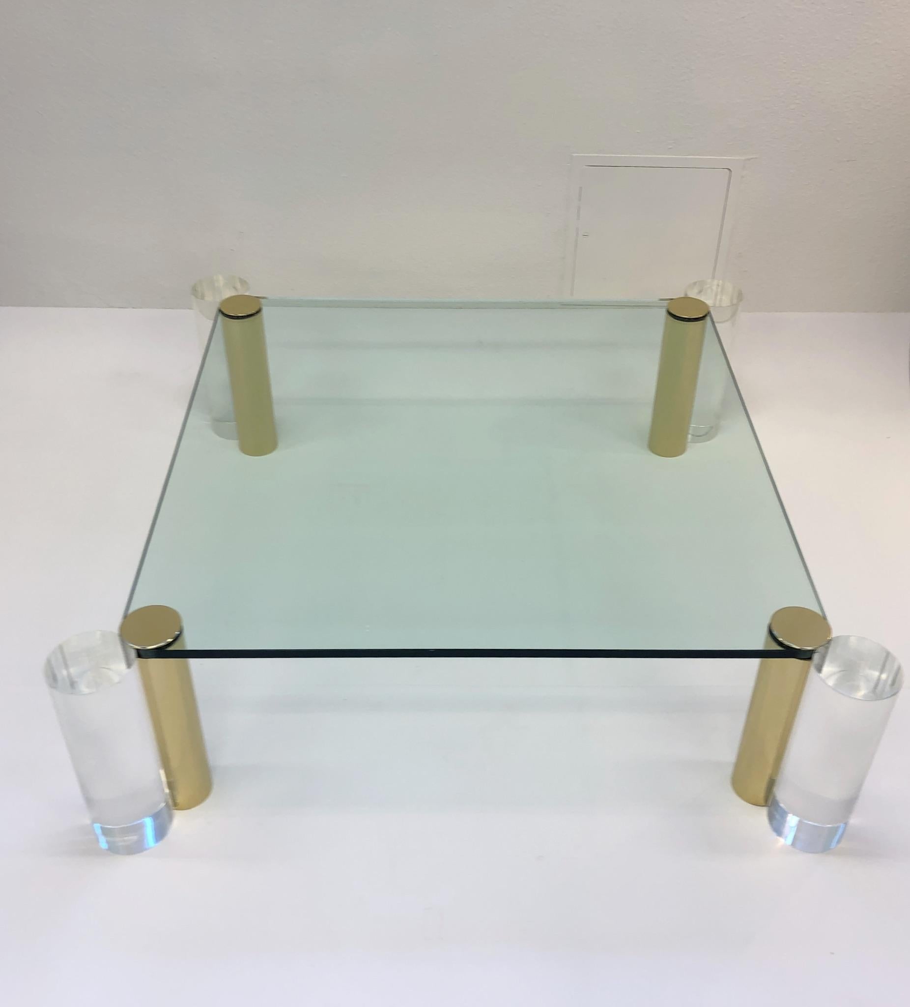 A glamorous 1970’ clear lucite and polish brass with glass cocktail table by Les Prismatiques. Glass top is 3/4” thick and 42” by 42”.

Overall Dim: 49” wide 49” deep 15” high.
    