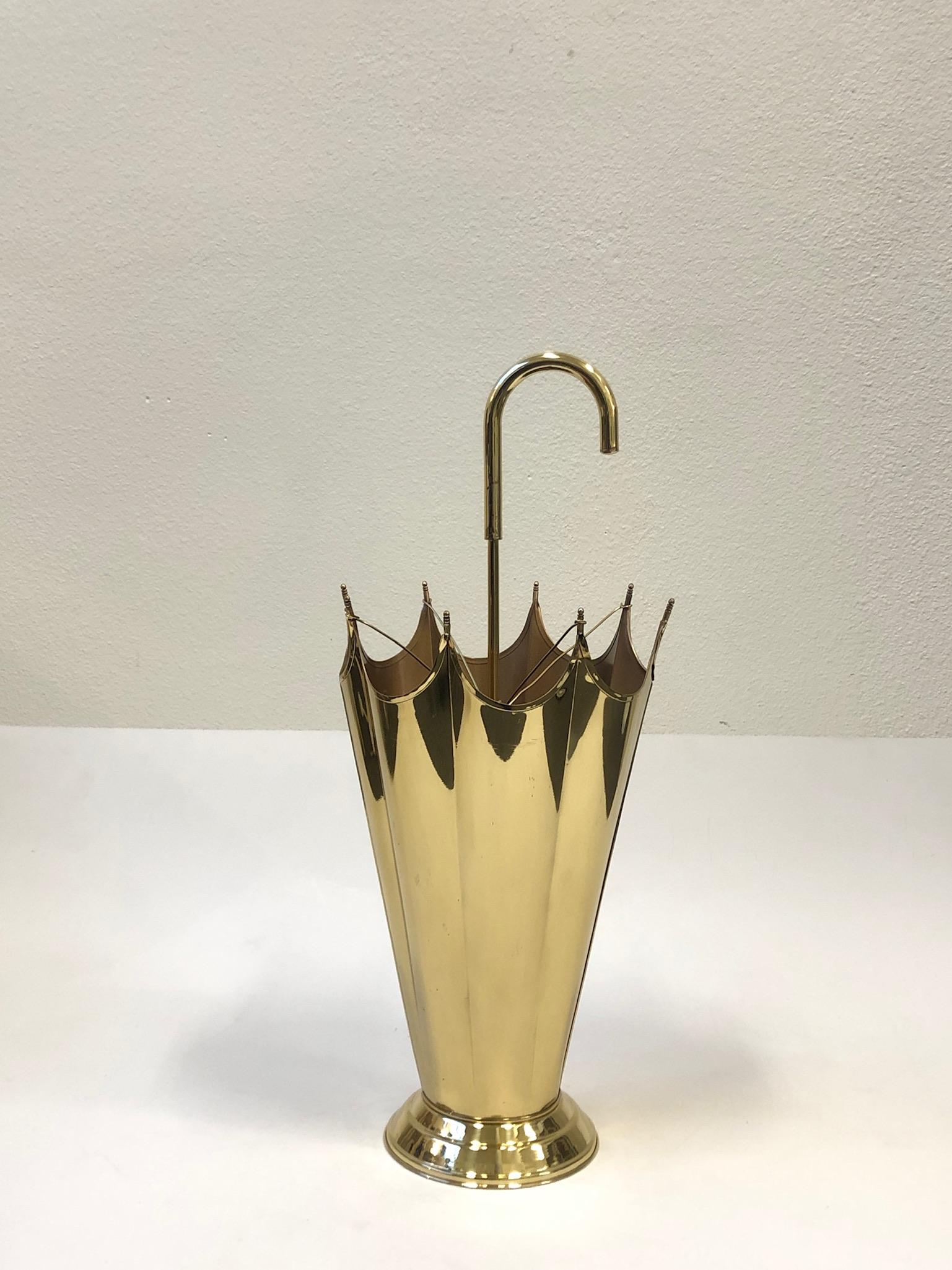 Beautiful 1970s polish brass umbrella holder in the shape of an umbrella. The holder has been newly professionally polish. Shows minor wear consistent with age. 
Dimensions: 11” diameter 26.5” high.