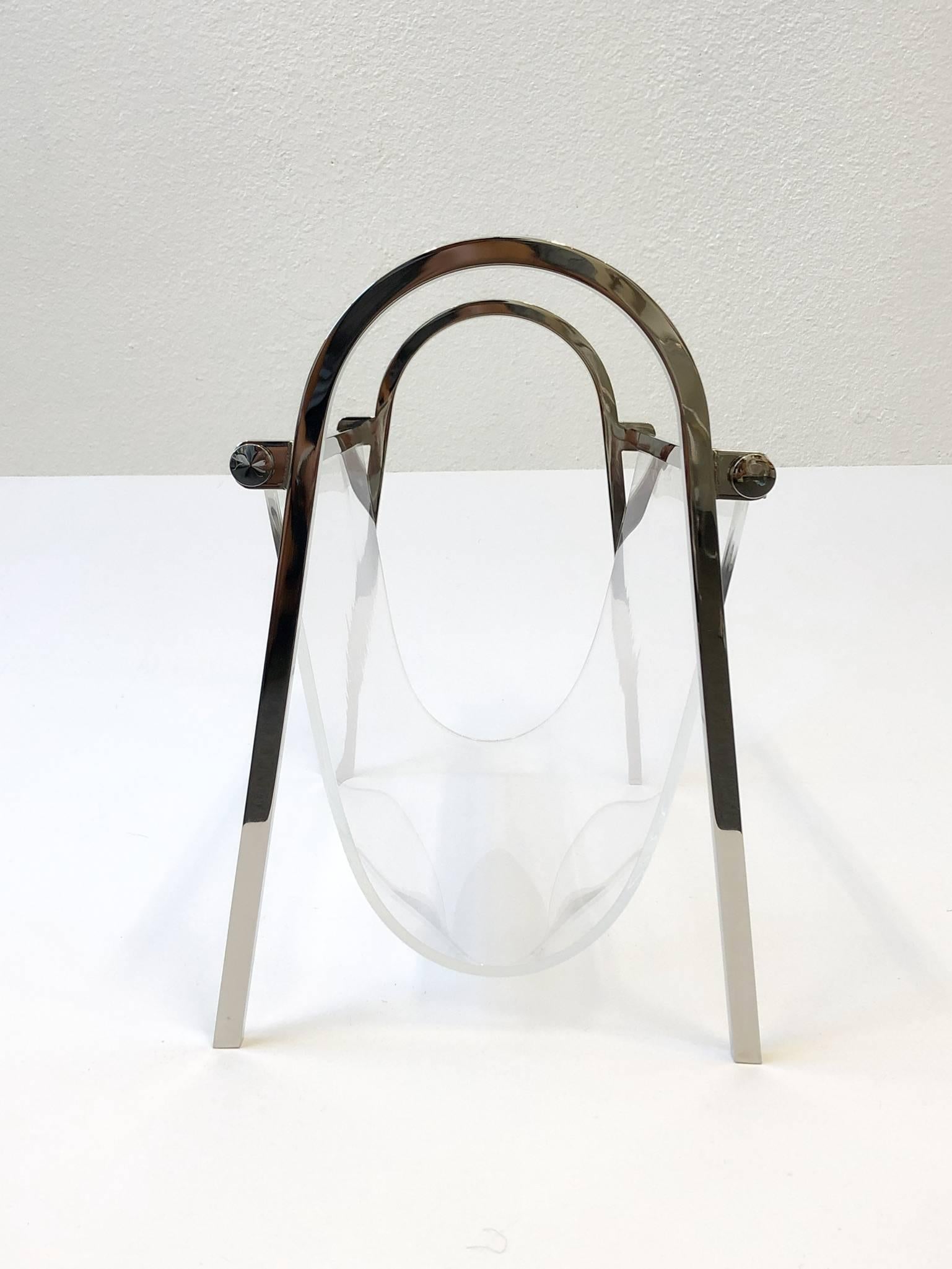 A beautiful 1970s polish nickel and clear Lucite “Arch Line” magazine holder by Charles Hollis Jones. 

Dimensions: 14.5” high 19” wide 10” deep.