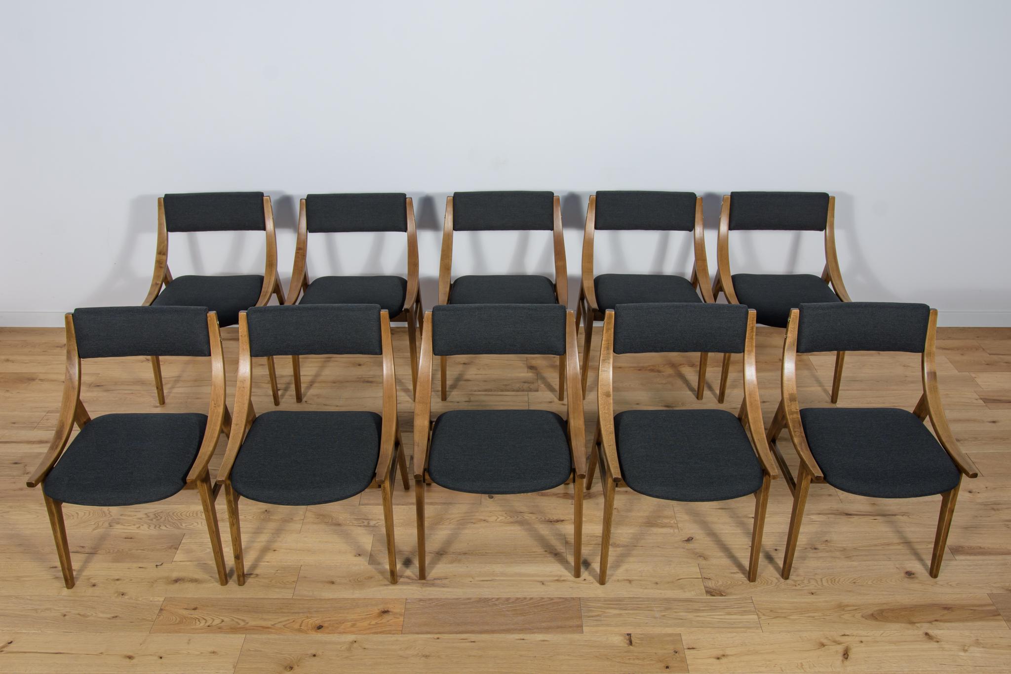 
This set of ten dining chairs was produced by Zamojska Furniture Factory in Poland circa 1970. It was designed by Juliusz Kędziorek. Completely restored. The sponges have been replaced. The seats have been reupholstered with new black fabric. The