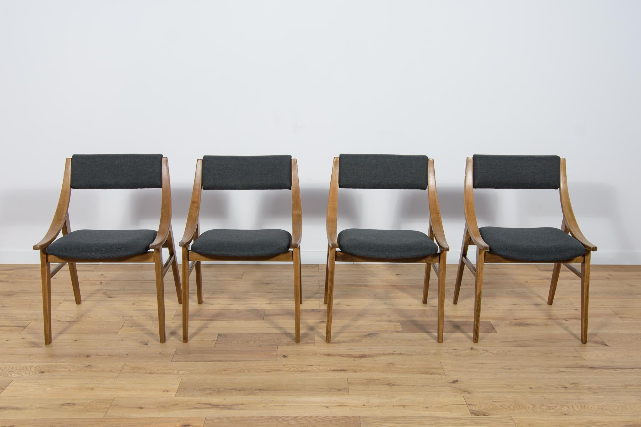 
This set of four dining chairs was produced by Zamojska Furniture Factory in Poland circa 1970. It was designed by Juliusz Kędziorek. Completely restored. The sponges have been replaced. The seats have been reupholstered with new black fabric. The