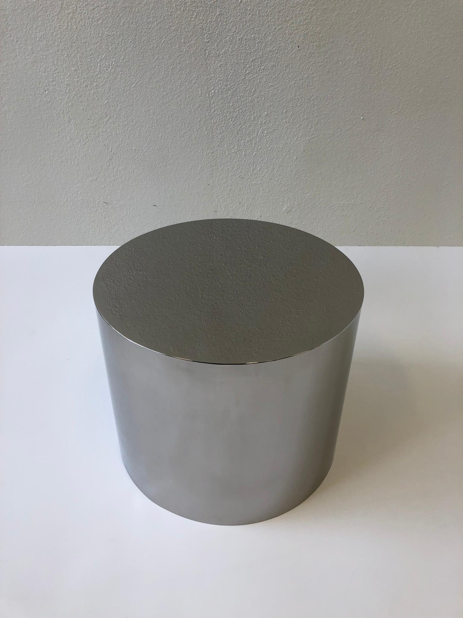 A 1980s polish stainless steel drum side table or cocktail table by Brueton. The drum is constructed of stainless steel and then mirror polished. The drum can be used by it self as a side table or a cocktail table with a glass top. The drum is