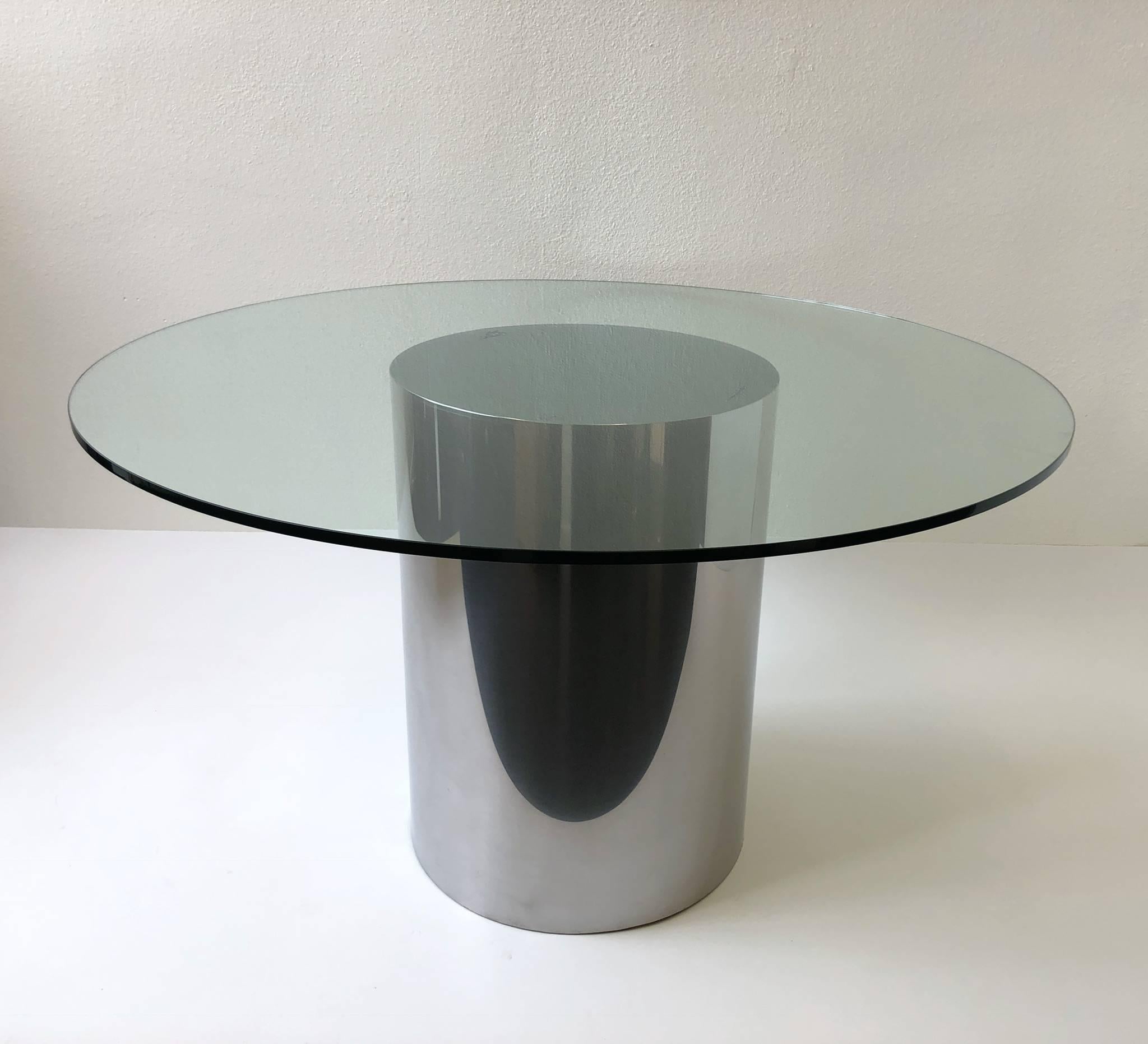 A polish stainless steel and glass drum dining table by Brueton. Newly professionally polish and new 48” diameter 1/2” thick glass top.

Dimensions: 48” diameter 28.5” high.
Just drum base: 20” diameter 28” high.