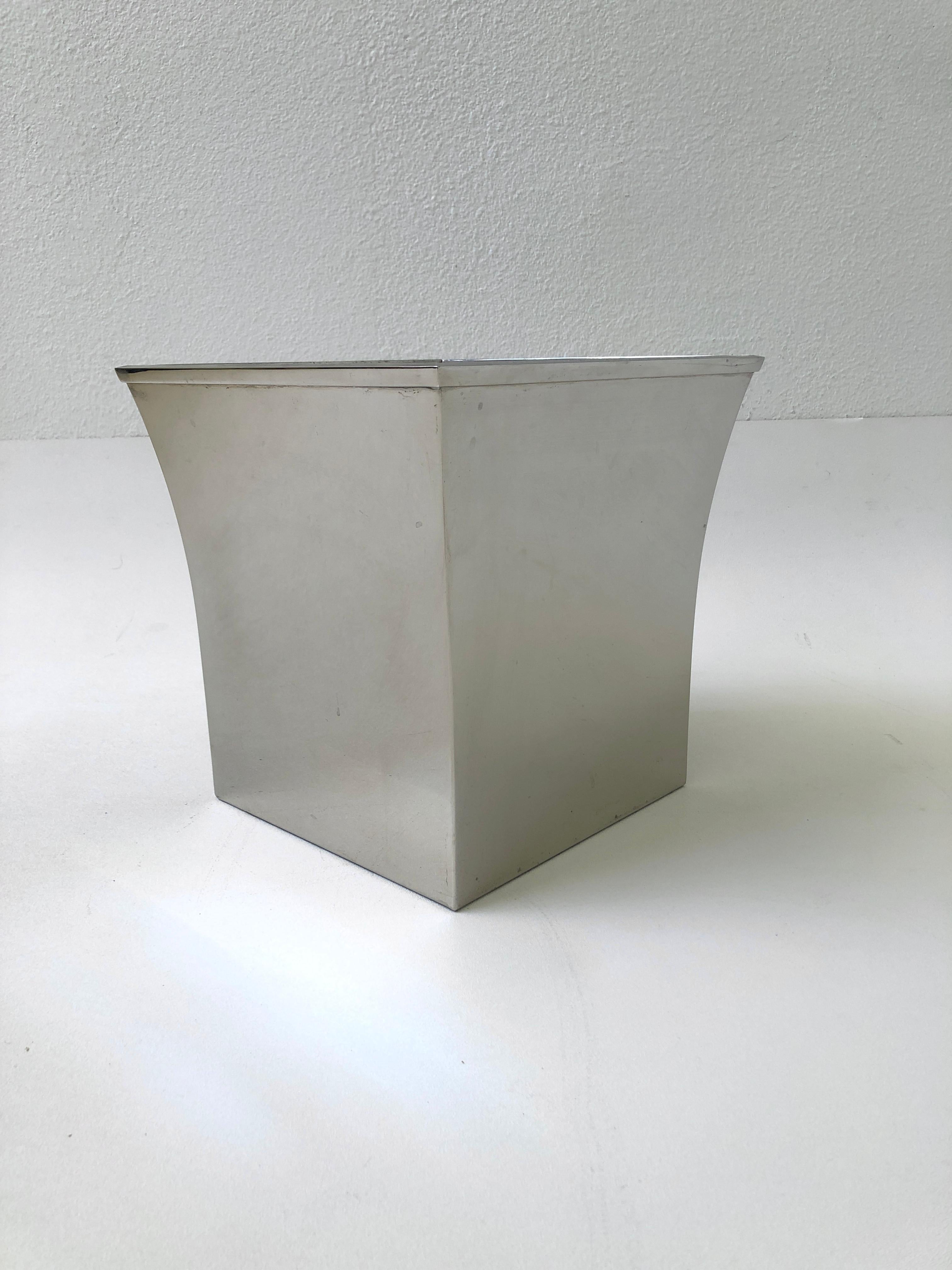 A glamorous 1980’s solid polish stainless steel wastebasket by Karl Springer.
Out of a Steve Chase designed estate. We also have one available in polish brass. 
Newly professionally polished.
Measurements: 11.25” high, 11” wide, 11” deep.