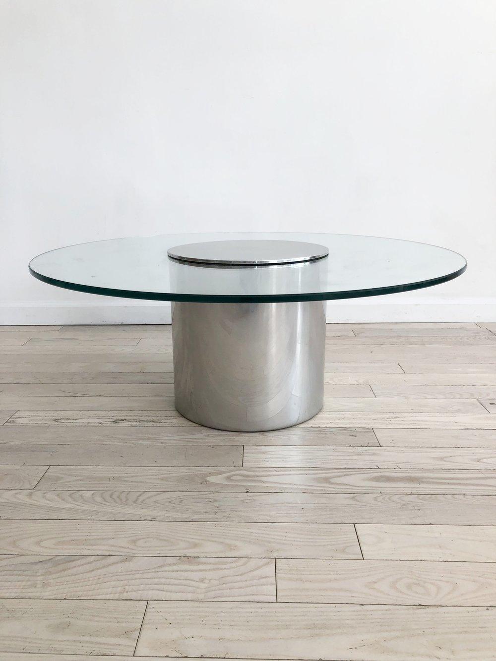 Ultra sleek polished drum table made of aluminium drum base and circle glass top. Designed by Paul Mayen for Architectural Supplements . Very unique design that features a lid atop the glass, to create the illusion that the metal drum pierces the