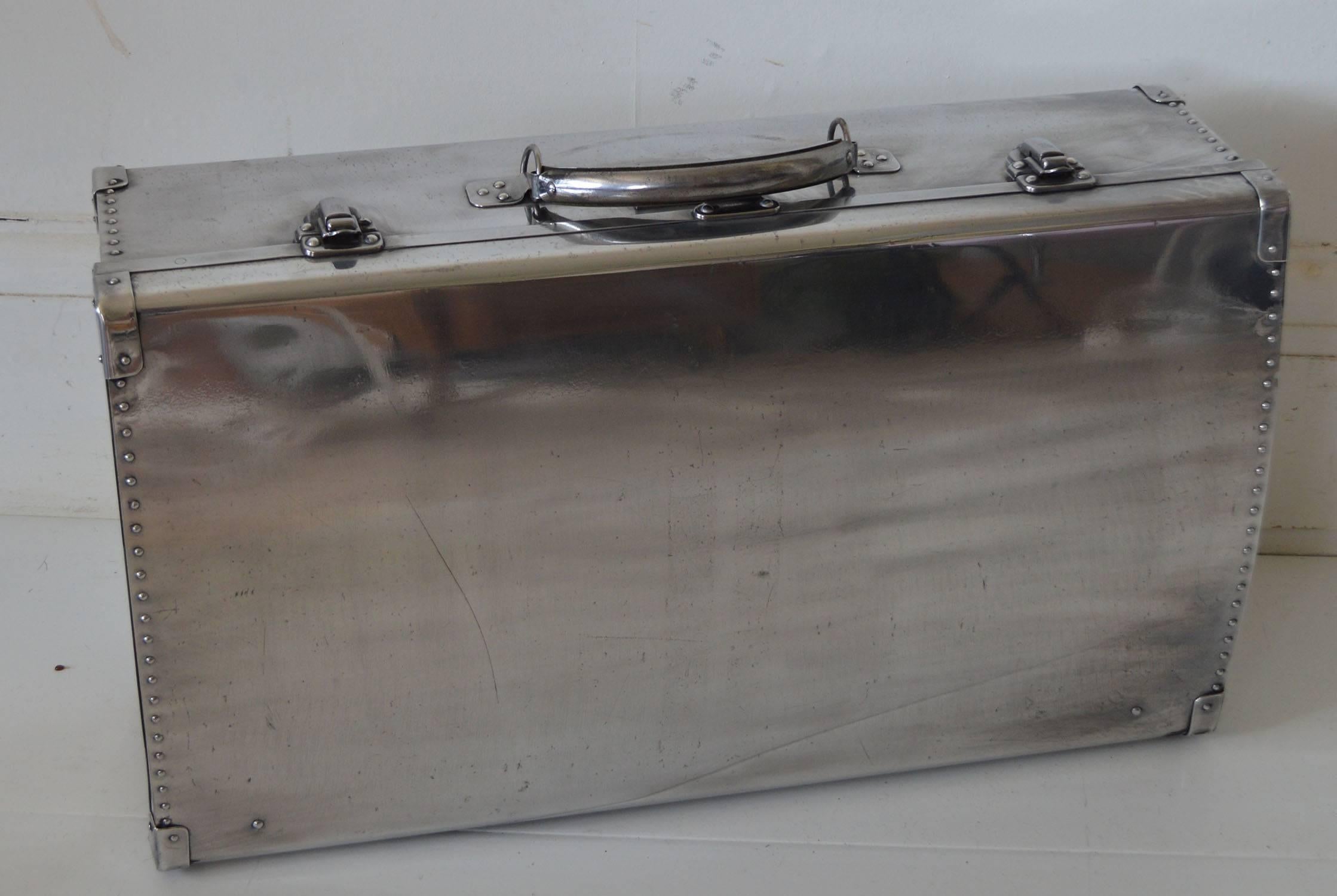 Super polished aluminium suitcase made by the Heston Aircraft Co. London, England, 1940s.

Interesting shape with a curved top and bottom. 

They were made from the surplus aluminium after the war.

Functional with clean interior. Very light.
