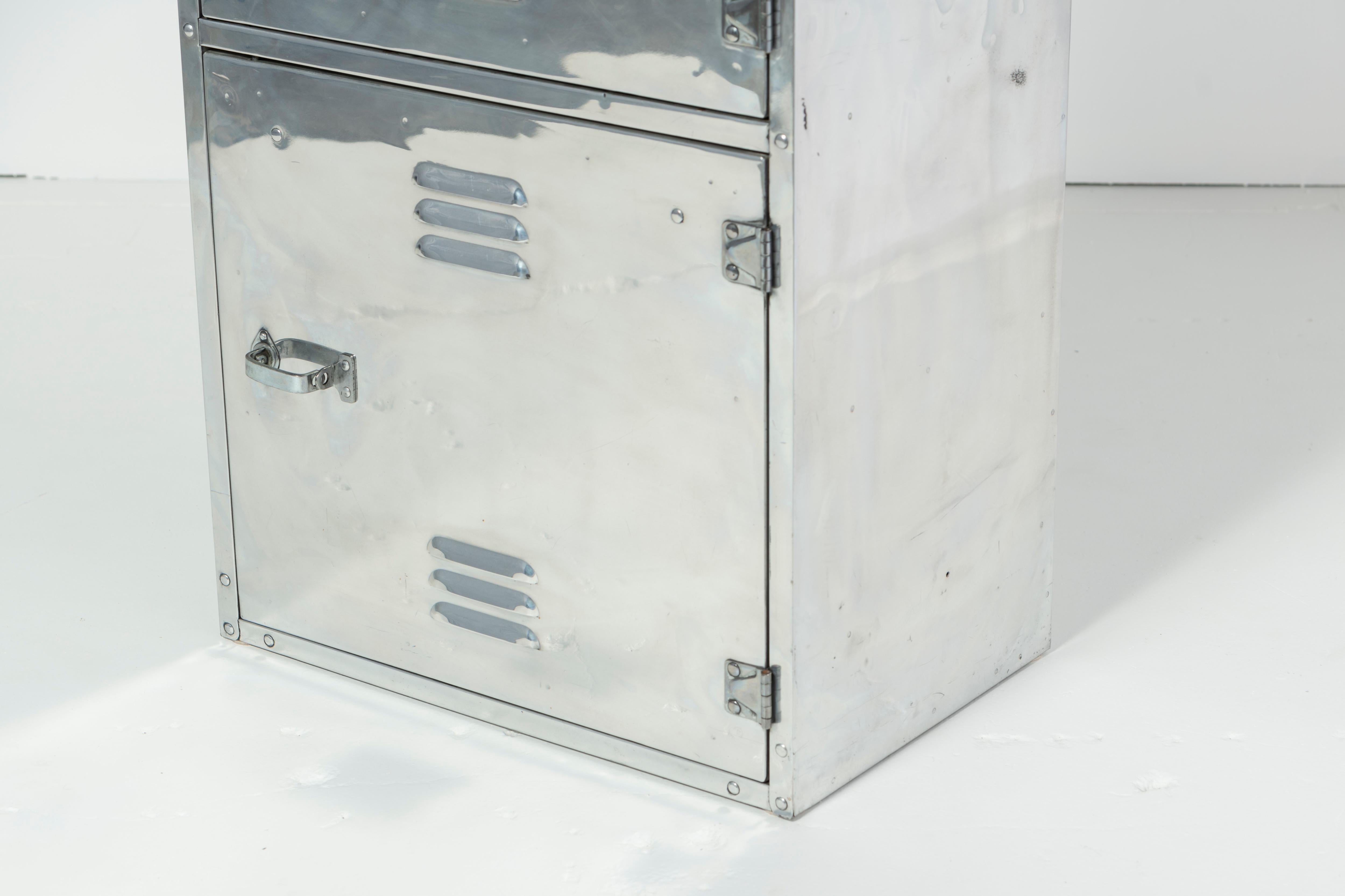 A 3-door polished aluminum foot locker. Behind each door are 2 drawers and 5 shelves. Very functional locker, serving a myriad of applications.