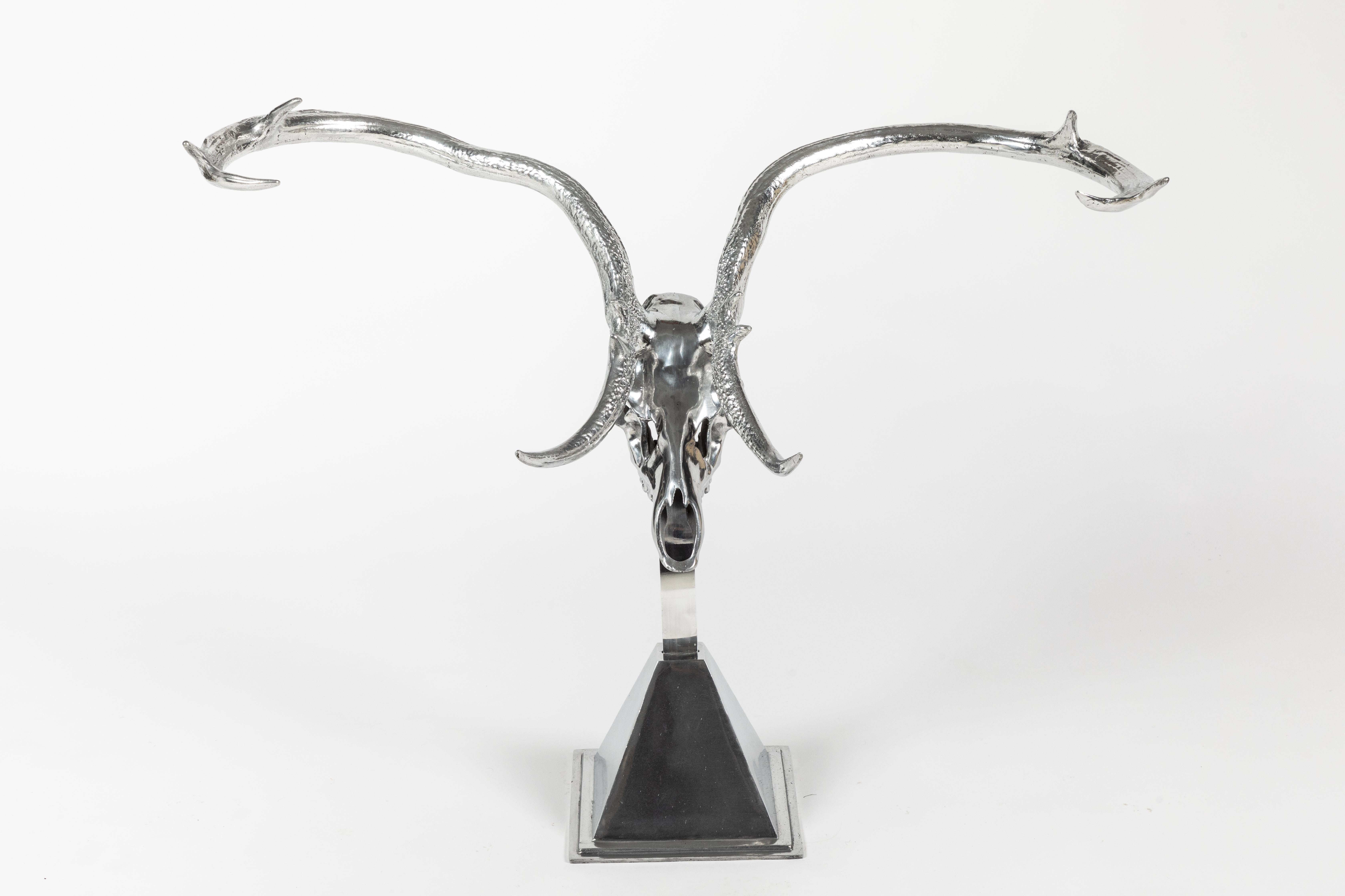 A polished aluminum chital deer skull on an original base by Arthur Court. Skull can be removed from the base and hung on the wall if you prefer.