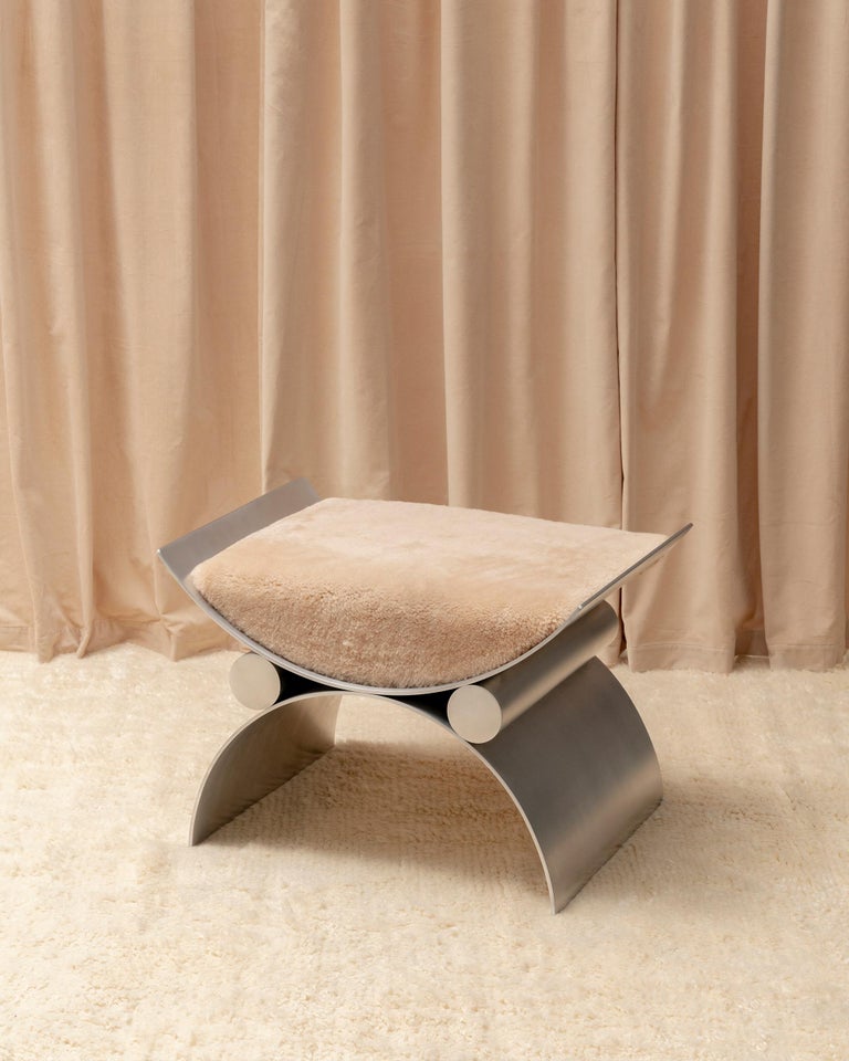 Made from rolled aluminum — in a non-directional satin finish — and sheepskin, the Magna chair, designed by Charles Constantine, takes its inspiration from the ancient Roman curule, an ornate, cross-framed seat typically reserved for magistrates and