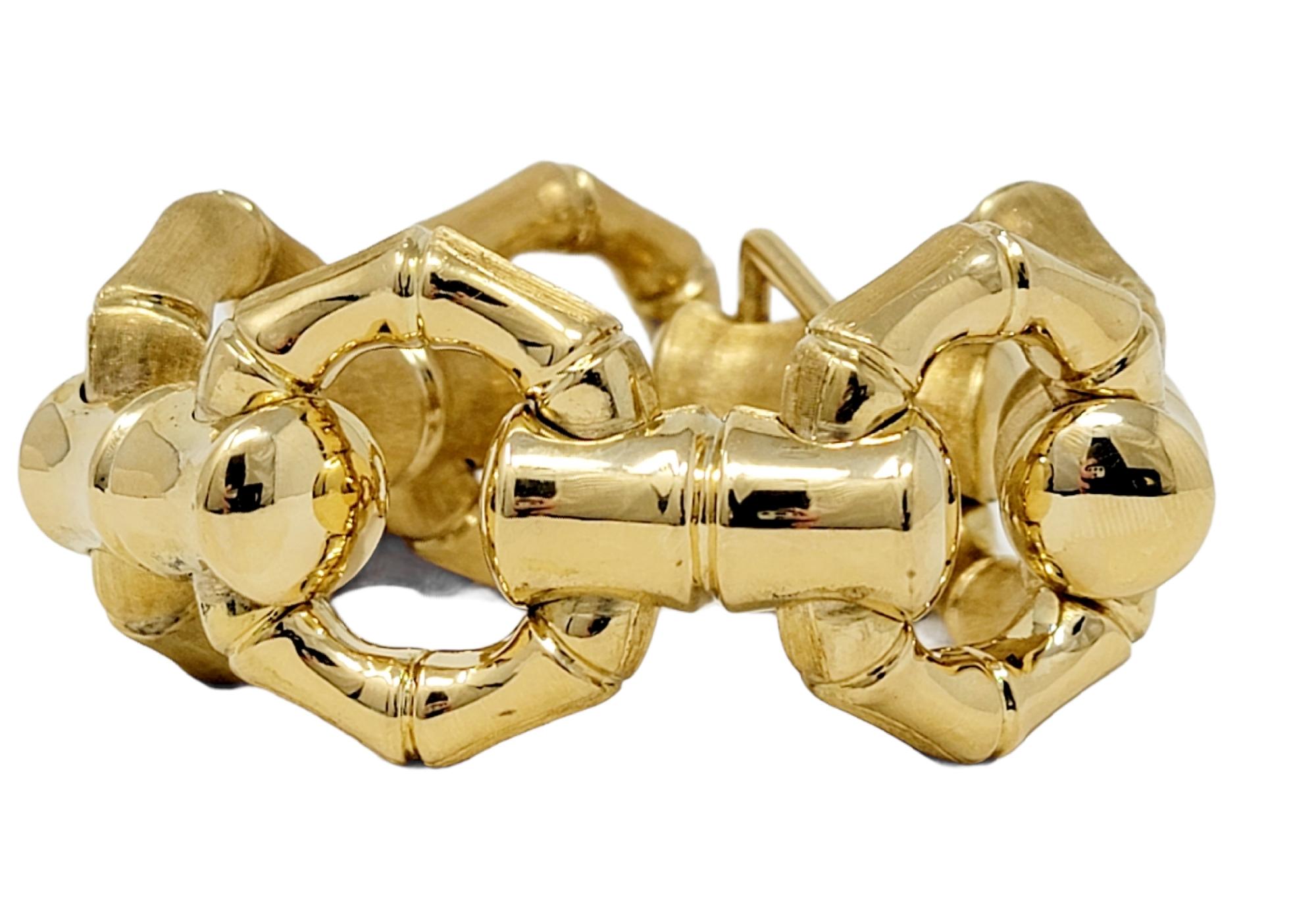 This incredible 18 karat yellow gold link bracelet with its chunky, over-sized style was built to make a statement! Featuring a reversible bamboo link design, this sizeable bracelet can be worn two ways for two unique looks. One side features a