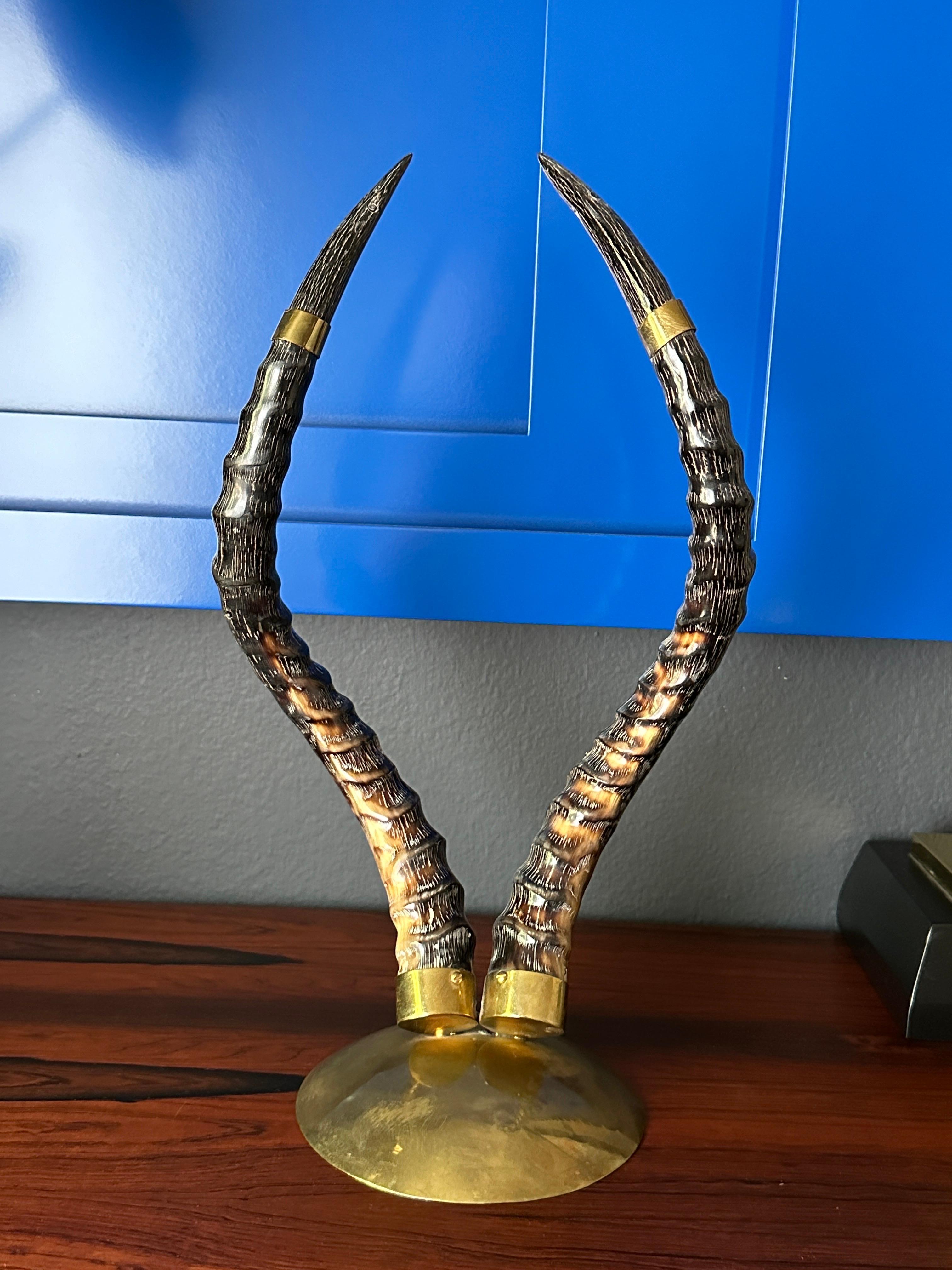 Polished antelope horns mounted on brass base.