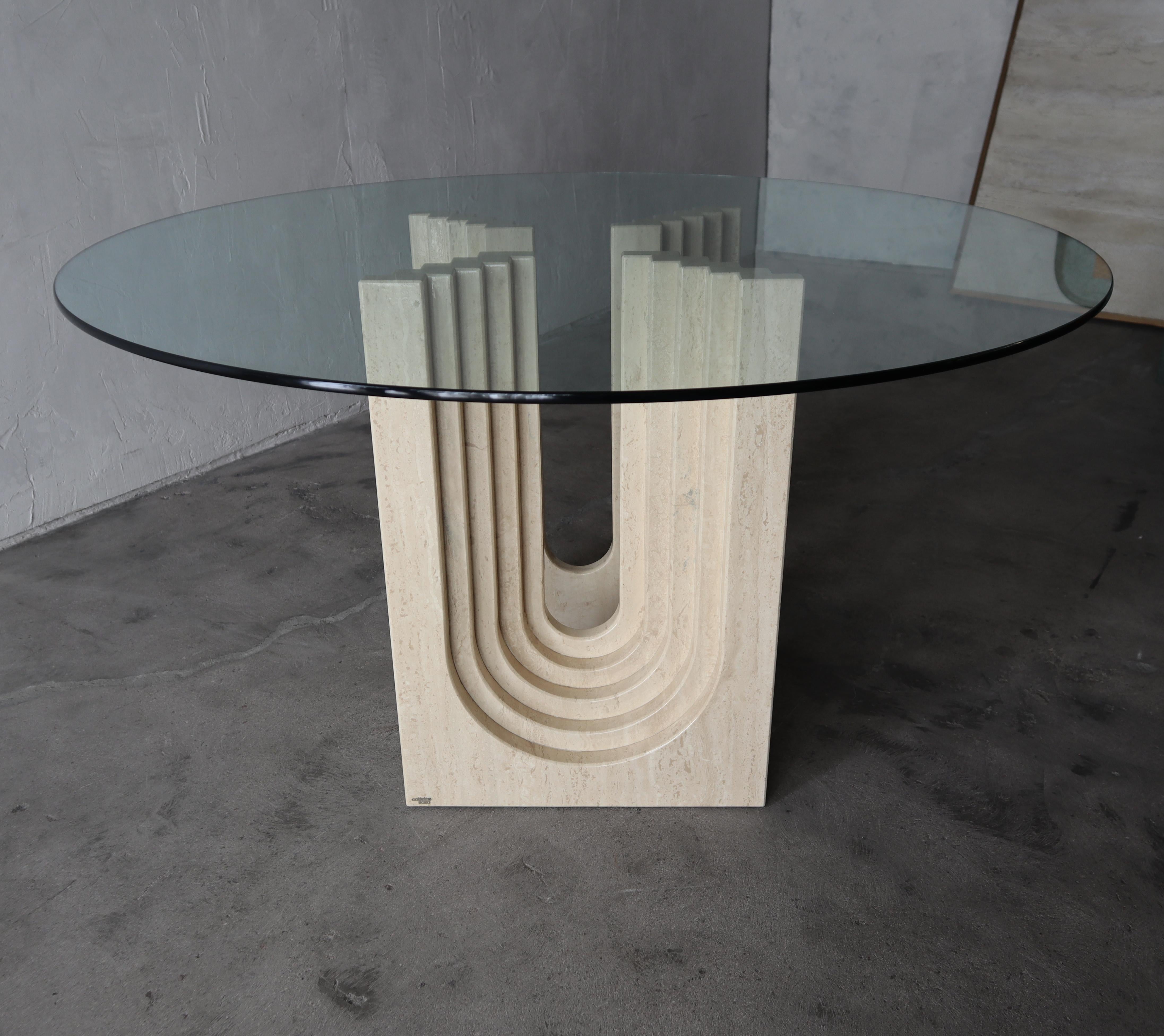 Nothing short of amazing. A pair of solid, polished travertine pedestals by Carlo Scarpa for Cattelan Italia.  The pedestals are designed in a staggered, architectural arch pattern giving them extreme depth and interest. 

Shown as a round dining