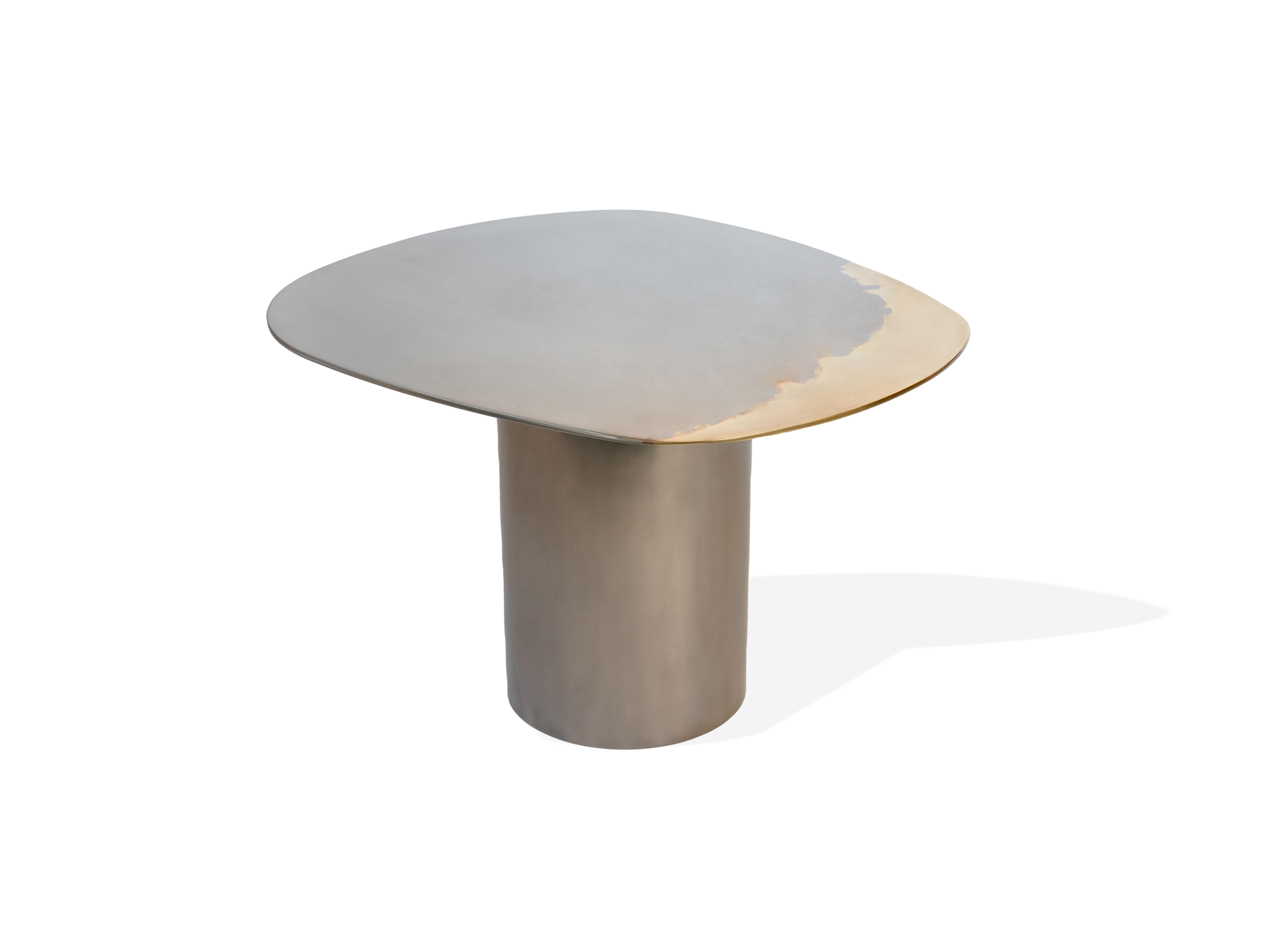 A set of nesting tables as part of the Transition collection, featuring unique, artistic mirror polished tabletops, crafted from brass and stainless steel on tubular bases.

Studio Warm has developed a distinctive, high-end, artistic finish blending