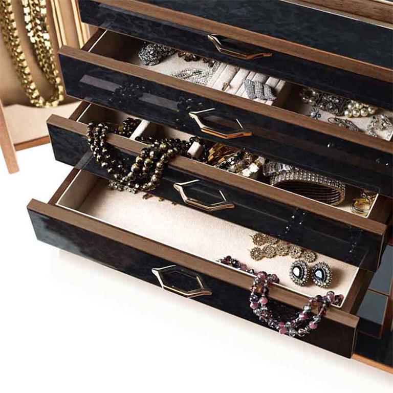 Jewelry chest in polished black bird’s-eye maple and mahogany, ultra suede lining, 24-karat gold-plated brass accessories. With necklace bars, lockable doors and five drawers. Adjustable mirror on the top section.