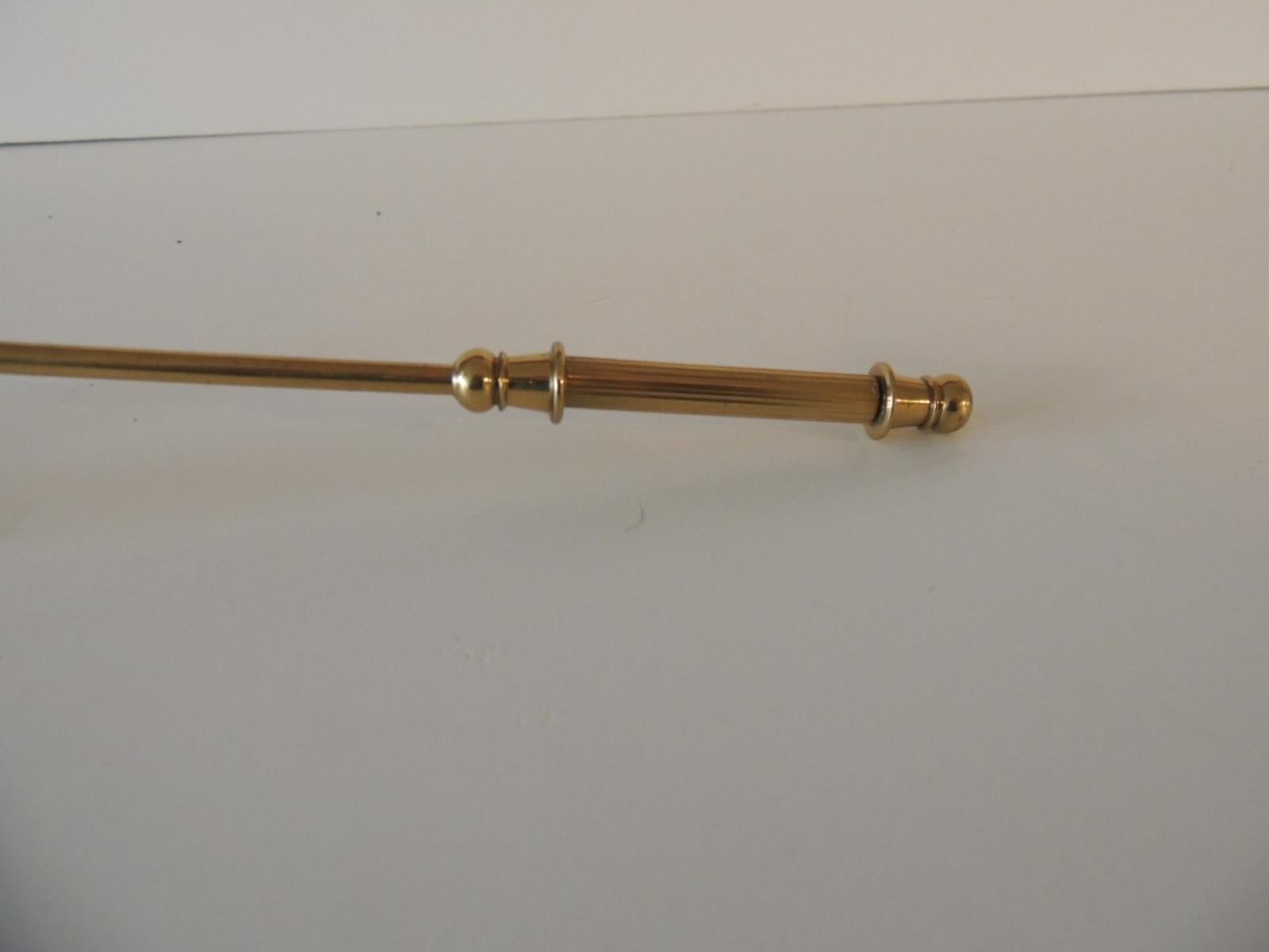 Polished brass articulated candle snuffer with ribbed handle.
Size: 10