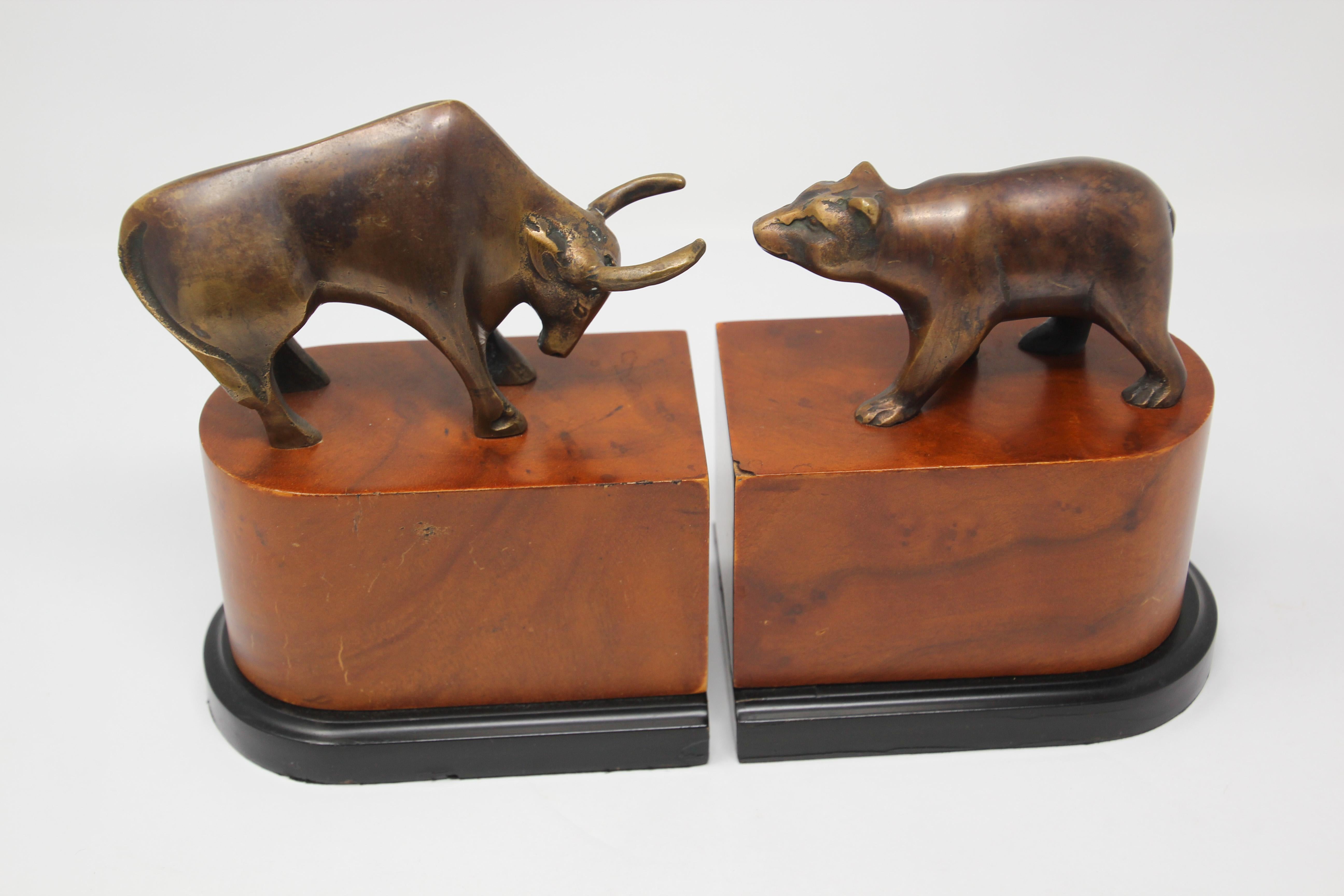 Art Deco style bronze bull and bear bookends.
Great on any desk the polished brass bull and bear on wood stands bookends or paperweights.
Great decorative bronze book ends.
Wall Street bull and bear broker decorative desk decoration.
Great