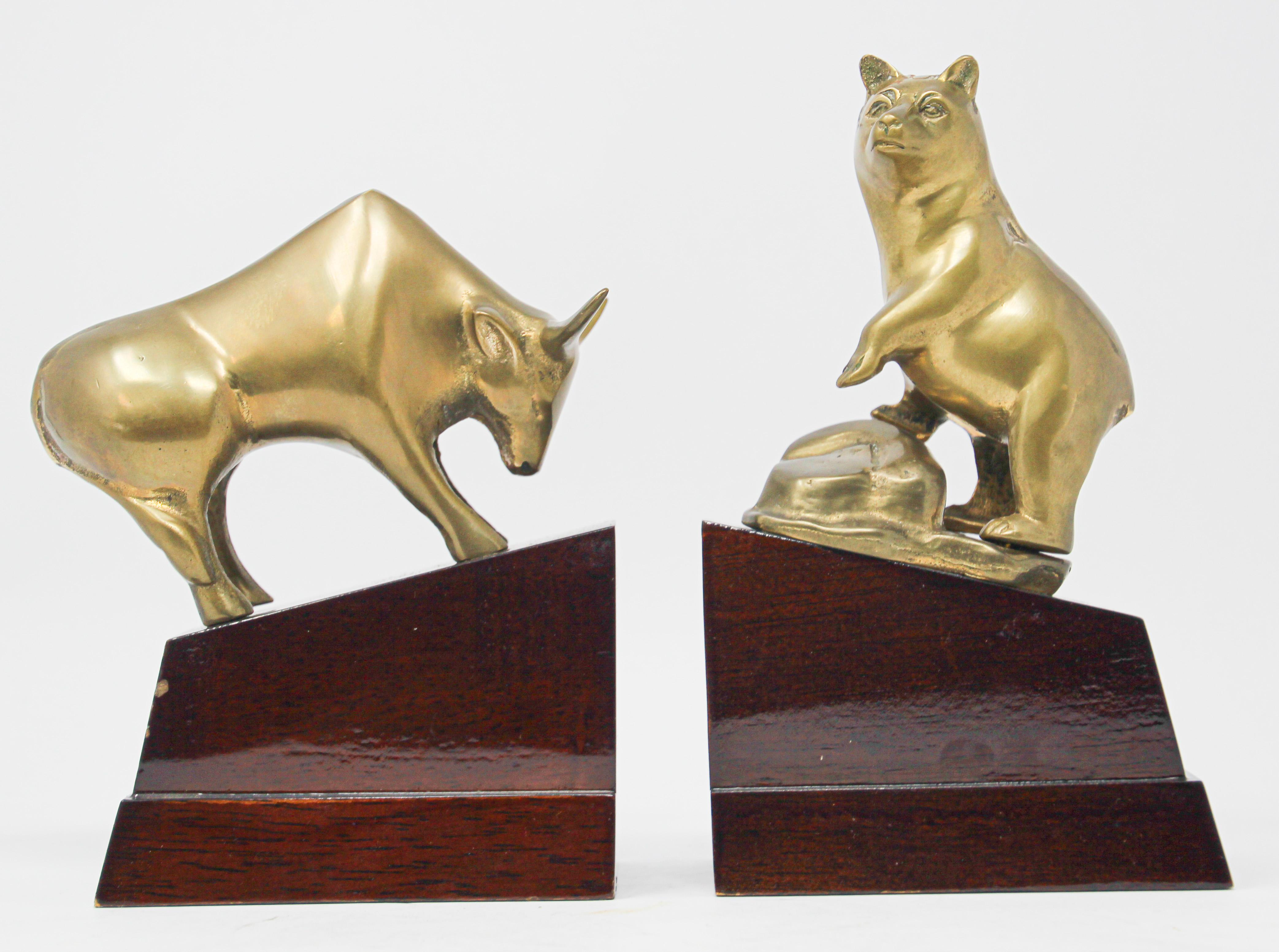 Art Deco style brass bull and bear bookends.
Great on any desk the polished brass bull and bear on wood stands bookends or paperweights.
Great decorative metal brass book ends.
Wall Street bull and bear broker decorative desk decoration.
Great
