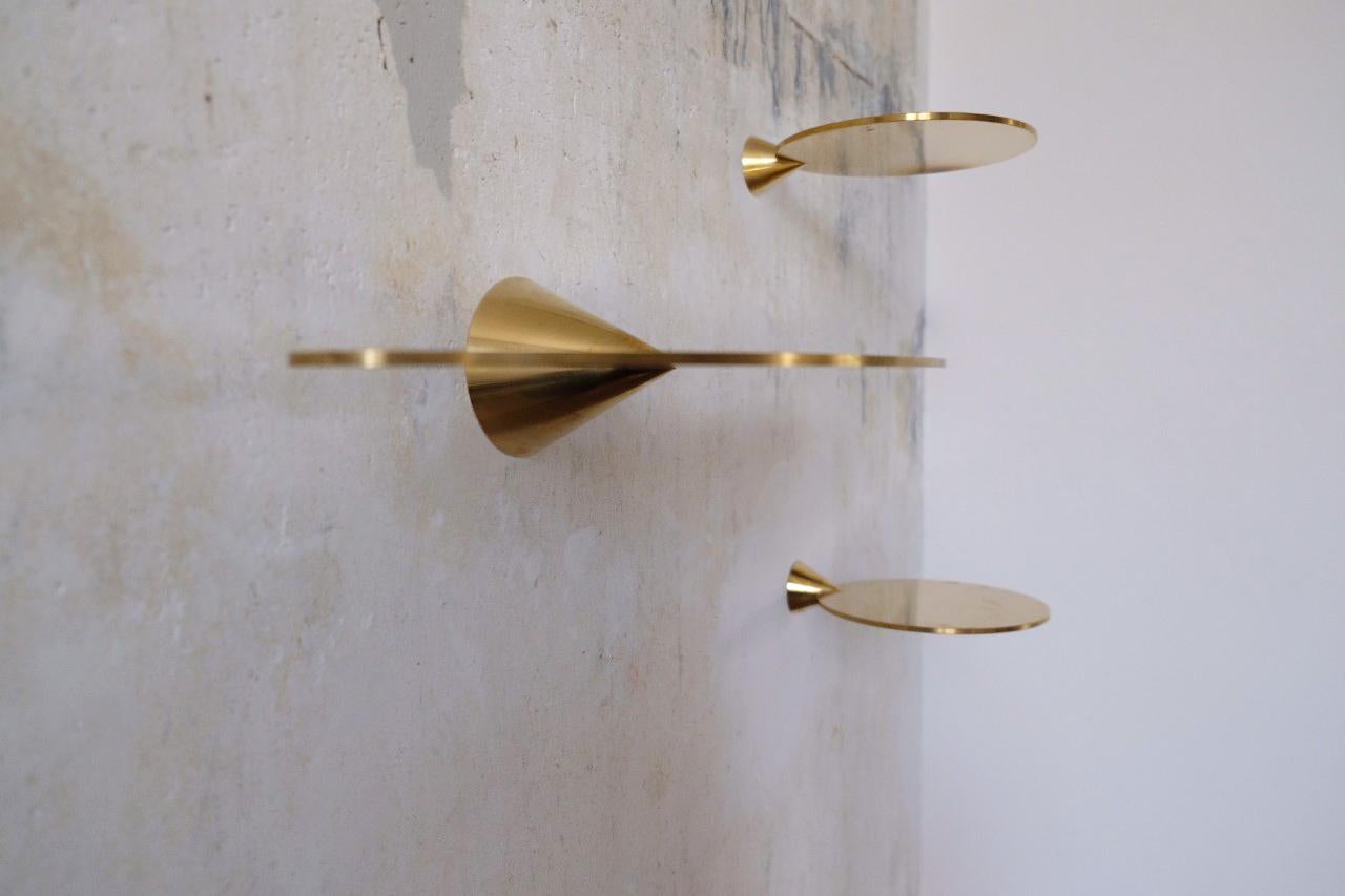 Polished brass floating shelves signed by Chanel Kapitanj
A minimalist shelving system. Like floating objects on the wall. These thin and aesthetic shelves made of two shapes, a plate and a cone, display your objects in a simple refined