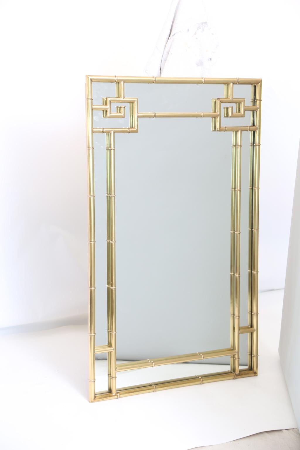 Mastercraft mirror, designed by Bernhard Rohne, of polished brass, its rectangular, faux bamboo frame with distinctive Greek key elements.

Stock ID: D2710.