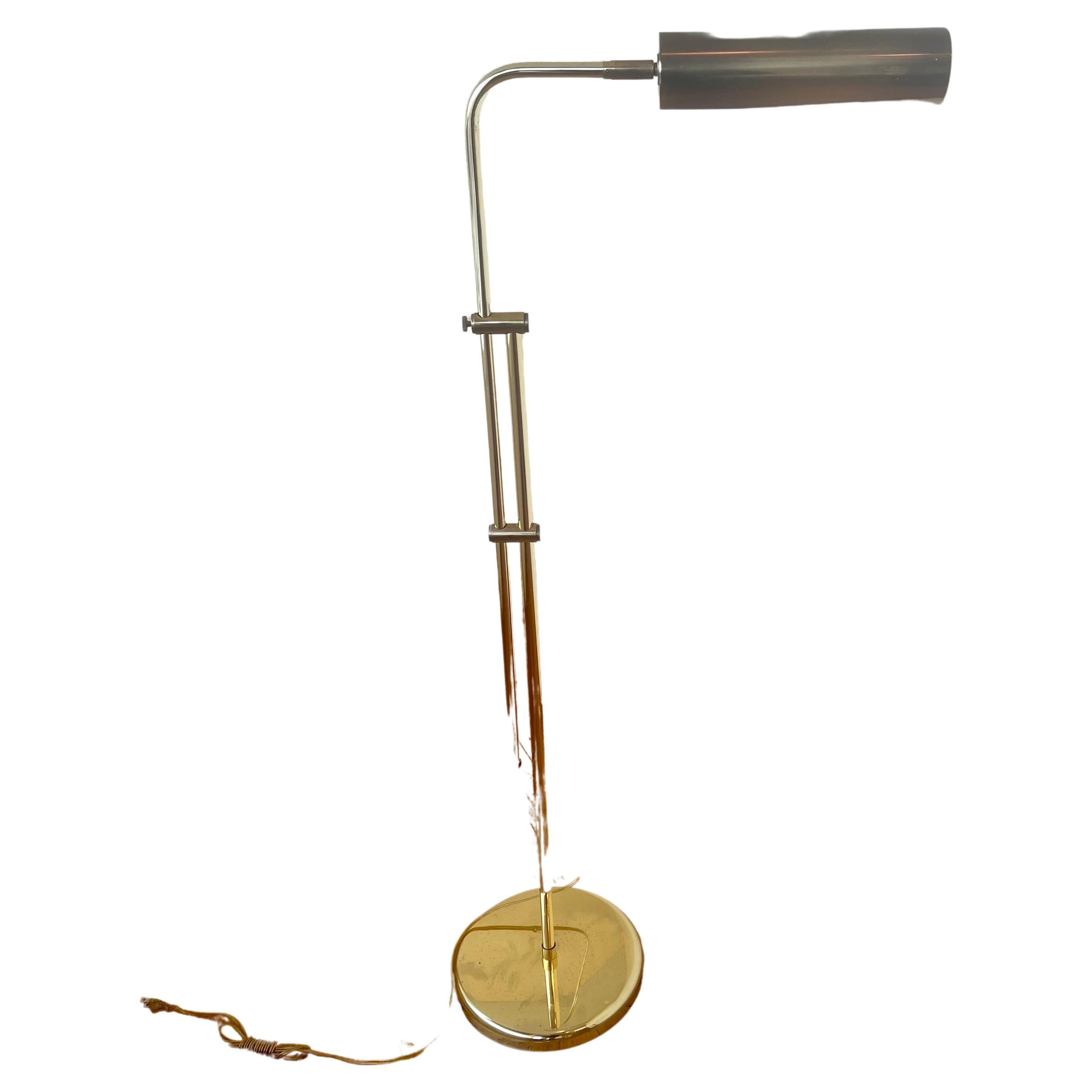 A very nice polished brass multi-directional pharmacy floor lamp we belive its by  Frederick Cooper, circa the 1970s. The lamp is multi-directional (goes up and down and the shade rotates from side to side) and is in good working condition. The lamp