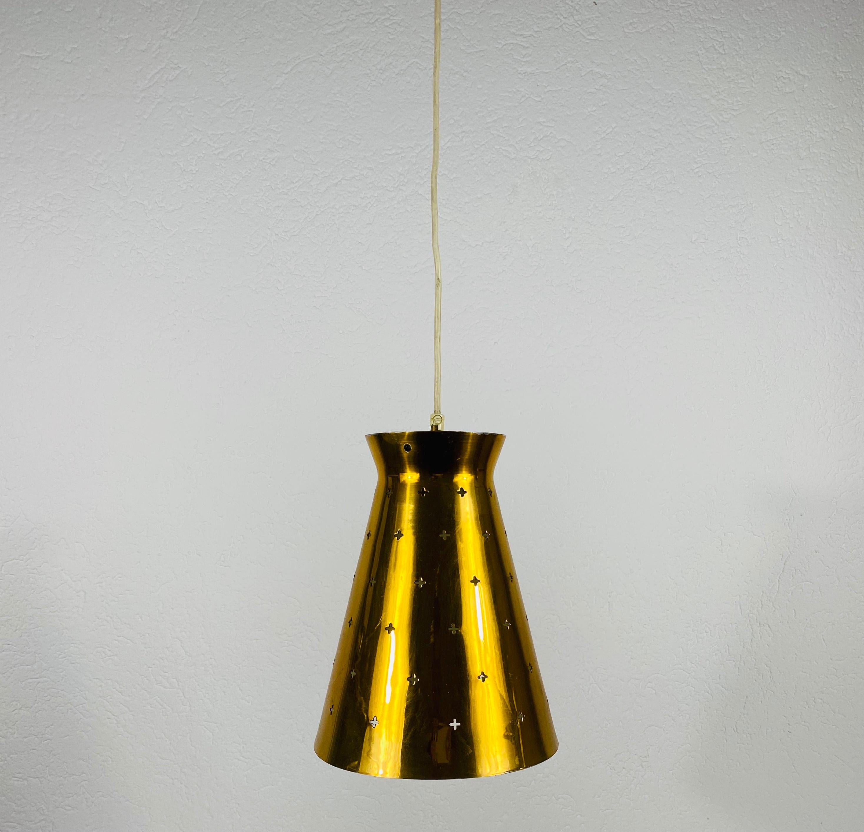 Very rare pendant lamp in the style of Paavo Tynell, made in Finland in the 1950s. The lighting is made of full of brass. It has many small holes which are creating beautiful light. The lighting requires one E27 (US E26) light bulb.

Measures: