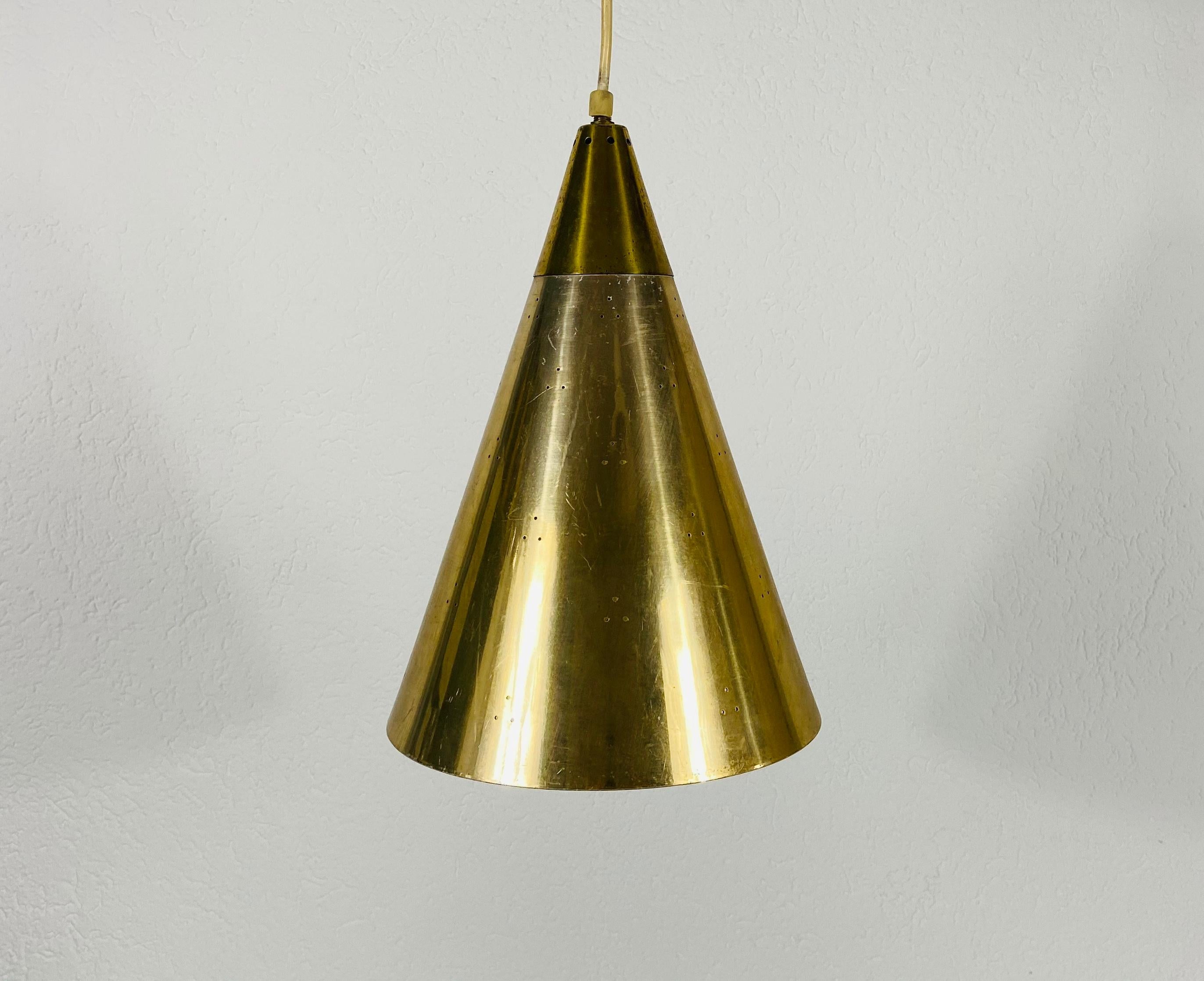 Very rare pendant lamp in the style of Paavo Tynell, made in Finland in the 1950s. The lighting is made of full of brass. It has many small holes which are creating beautiful light. The lighting requires one E27 light bulb.

Measures: Height of