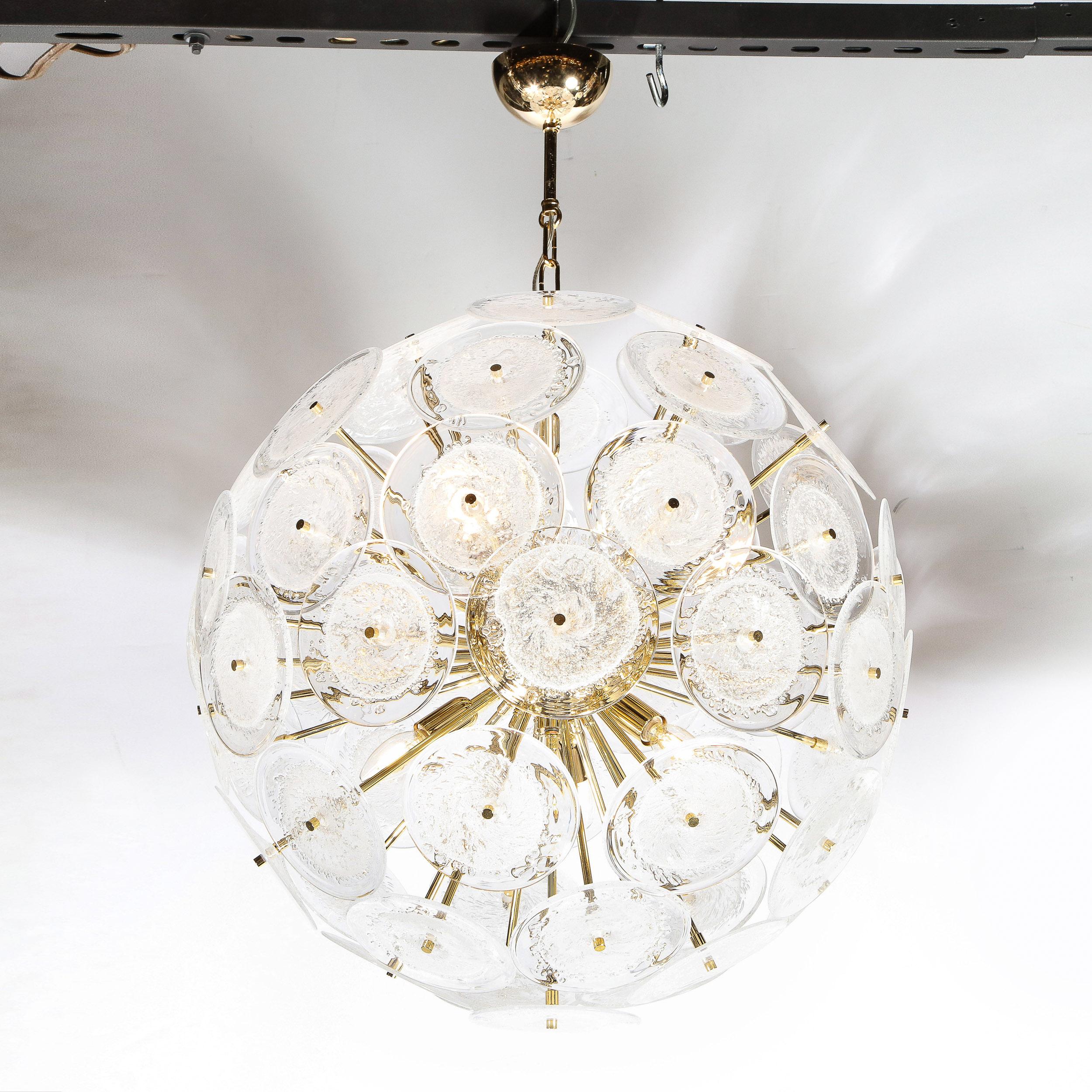 This dramatic and graphic sputnik was realized in Murano, Italy- the islands off the coast of Venice renowned for centuries for their superlative glass production. It features a wealth of polished brass rods emanating from circular body of the same