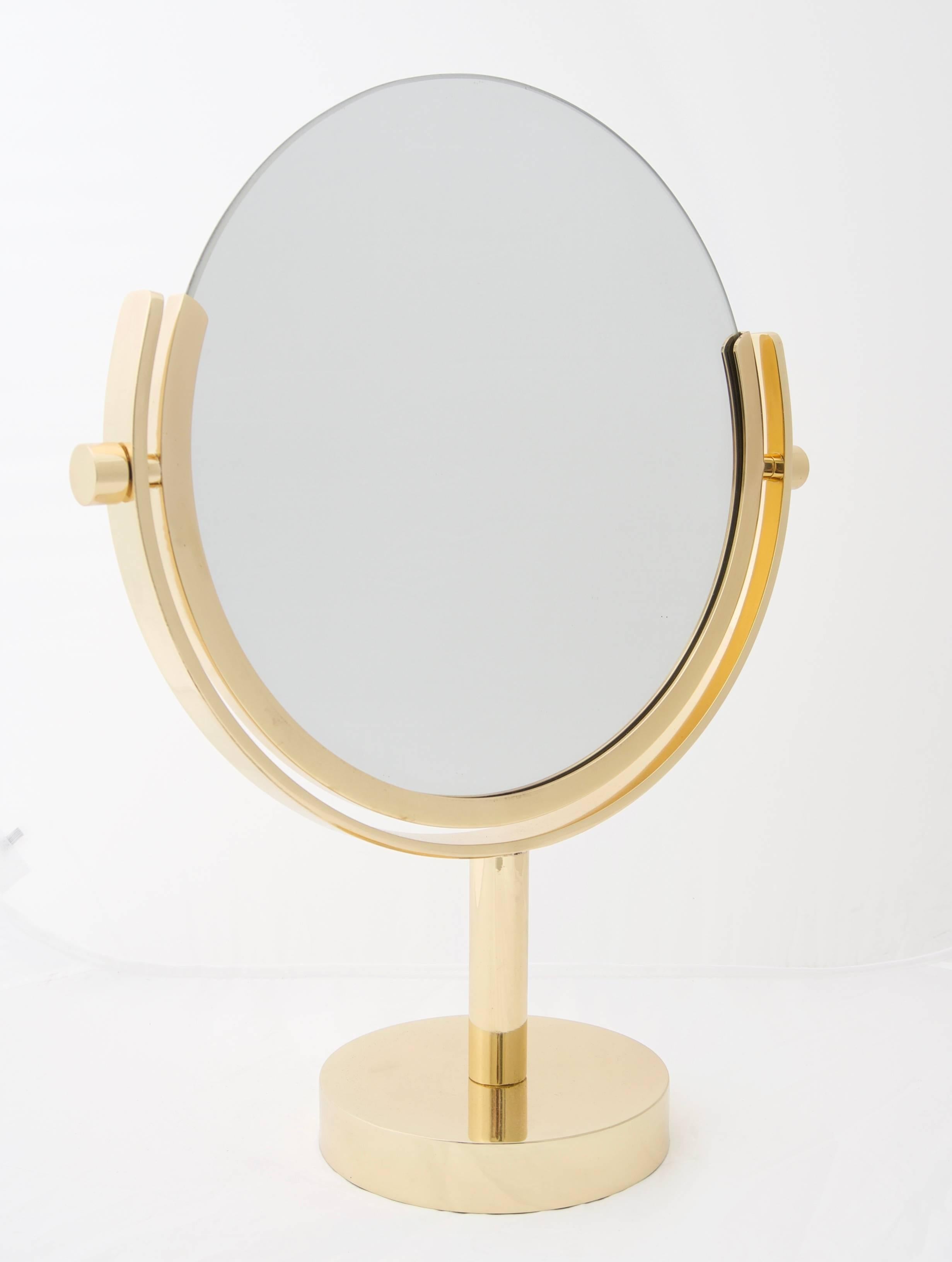 This stylish vanity mirror is by the iconic furniture designer Charles Hollis Jones and has been professionally polished and lacquered (no tarnishing). The pieces dates to the late 1970s or early 1980s. The piece can be held in your selected