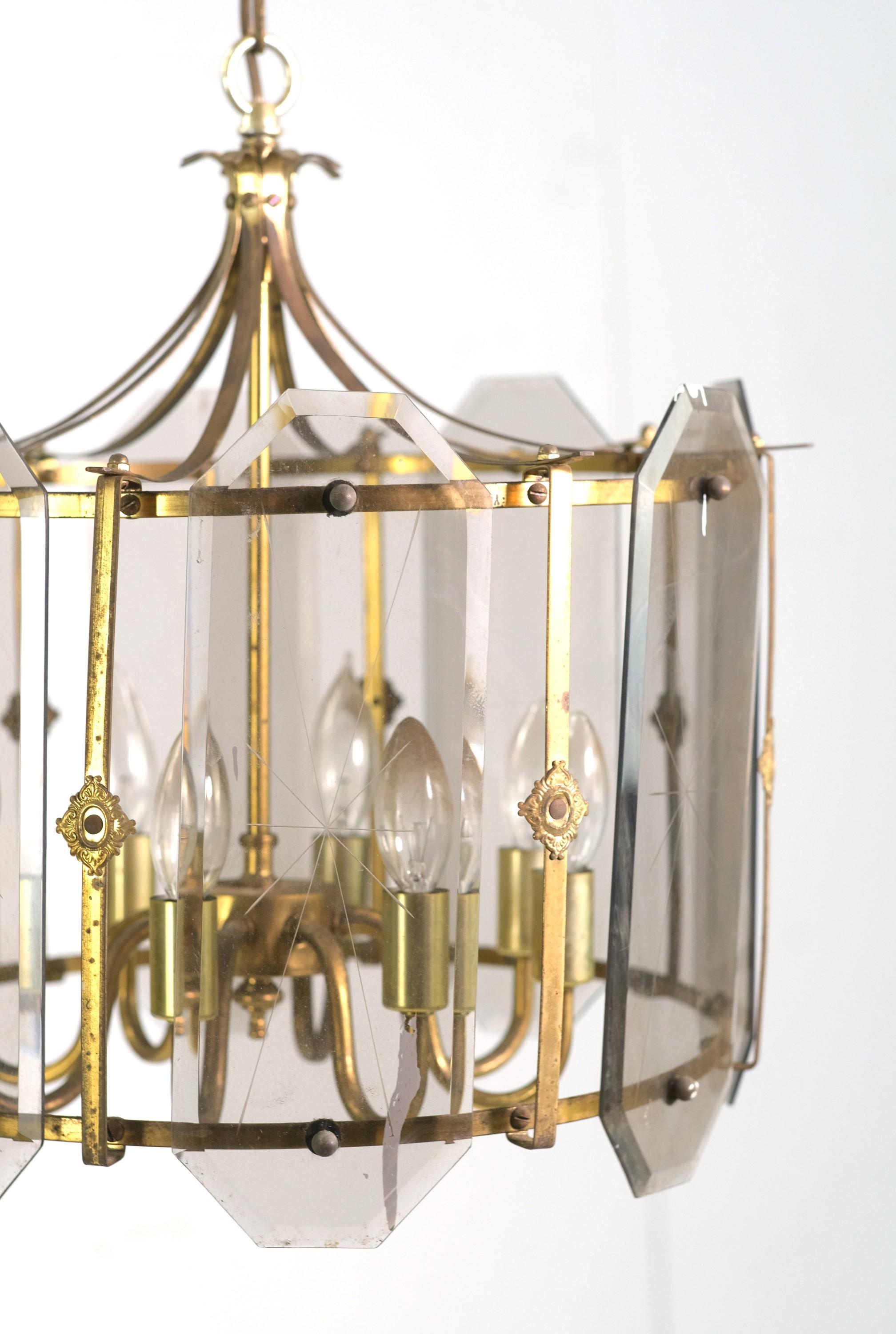 Eight arm brass pendant light with beveled and cut clear octagonal glass panes. Each panes features an etched center star design. The beveled glass panes also have a slight violet tint. Cleaned and restored. Please note, this item is located in our