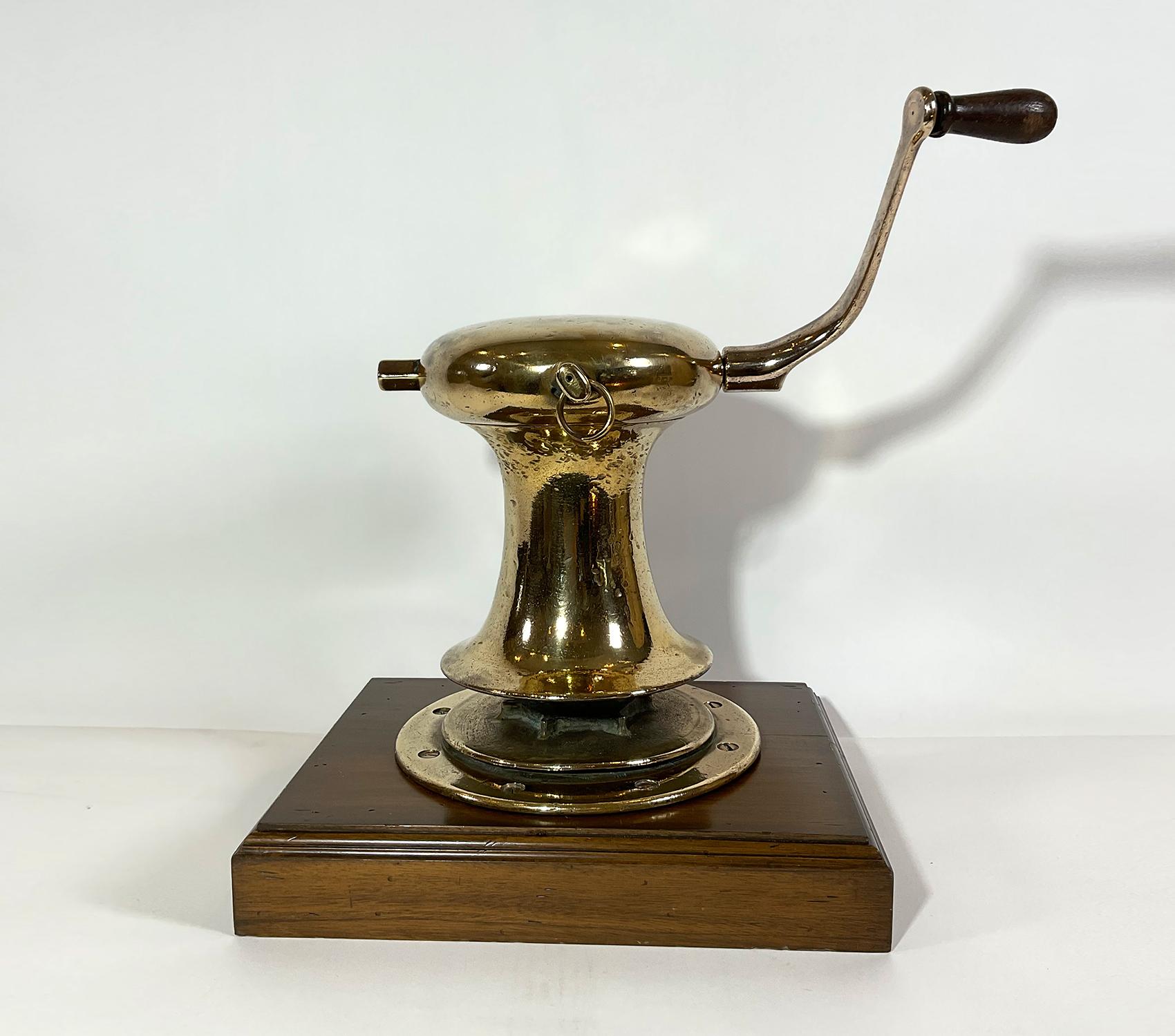 Outstanding early twentieth century yacht capstan by Herreshoff. With working gears, crank handle, speed switch, mounted to a thick wood base. Circa 1925.