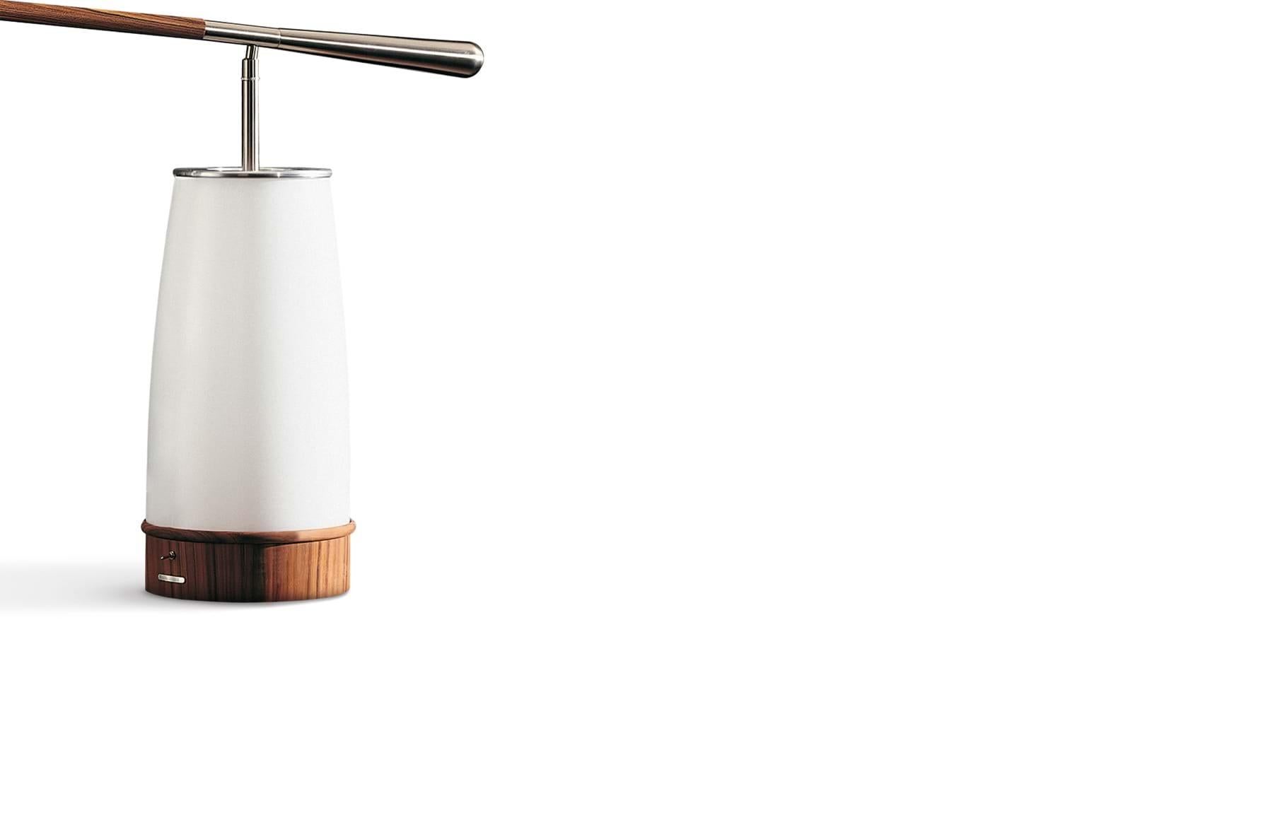  AFO Table Lamp is a table and reading lamp with the base in solid, polished Brazilian pau ferro wood and nickel-plated metal base. Designed by Chi Wing Lo in 2009, in AFO the static concept is completely overcome by the Directional head and by the