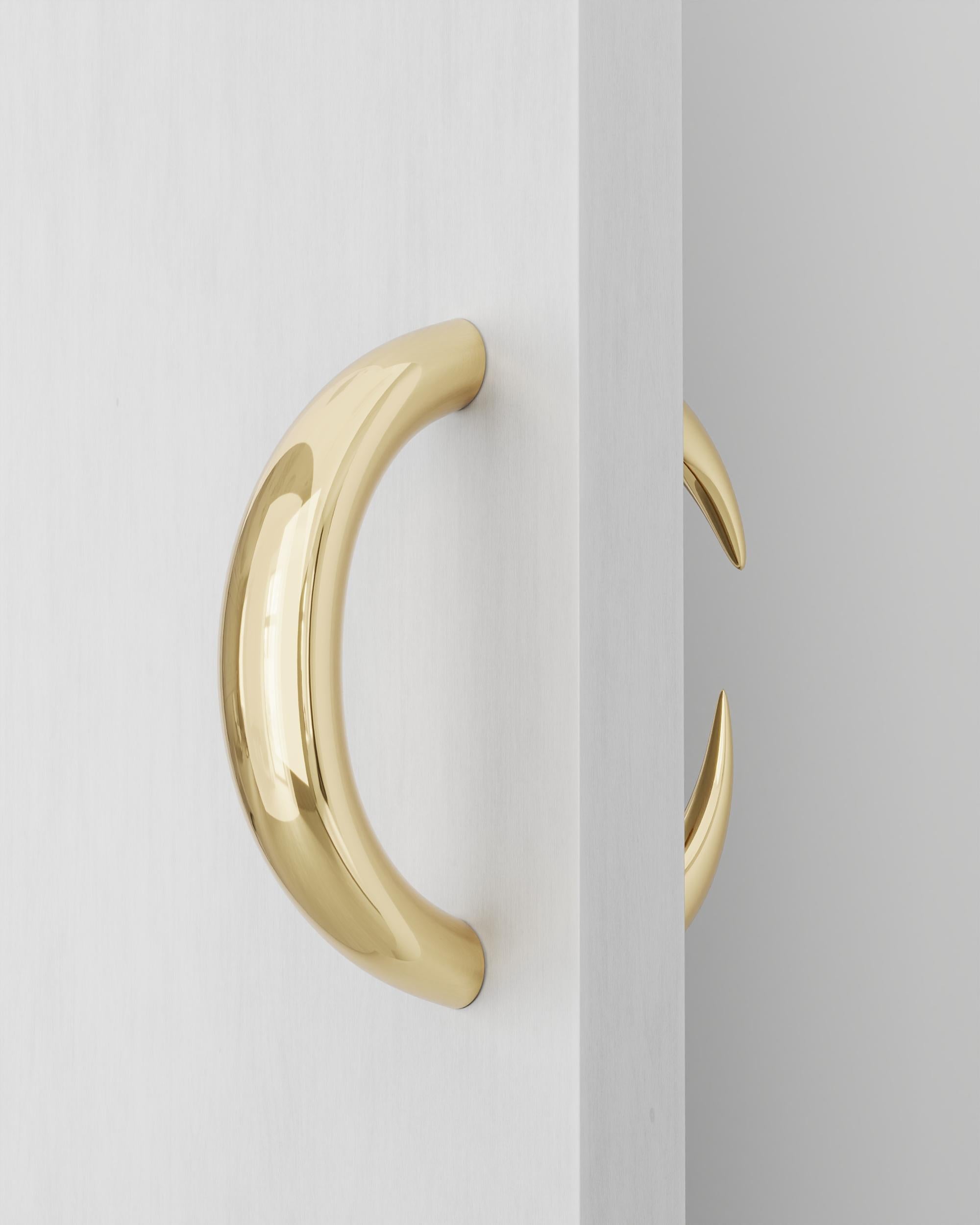 Polished Cast Brass Garra Door Hanger by Studio Orth
Dimensions: W 14 x D 6 x H 33 cm
Materials: Cast metal.
Finishes: Polished Cast Brass or Polished Cast Aluminum

About: 
Studio Orth is a multidisciplinary furniture and interior design firm,