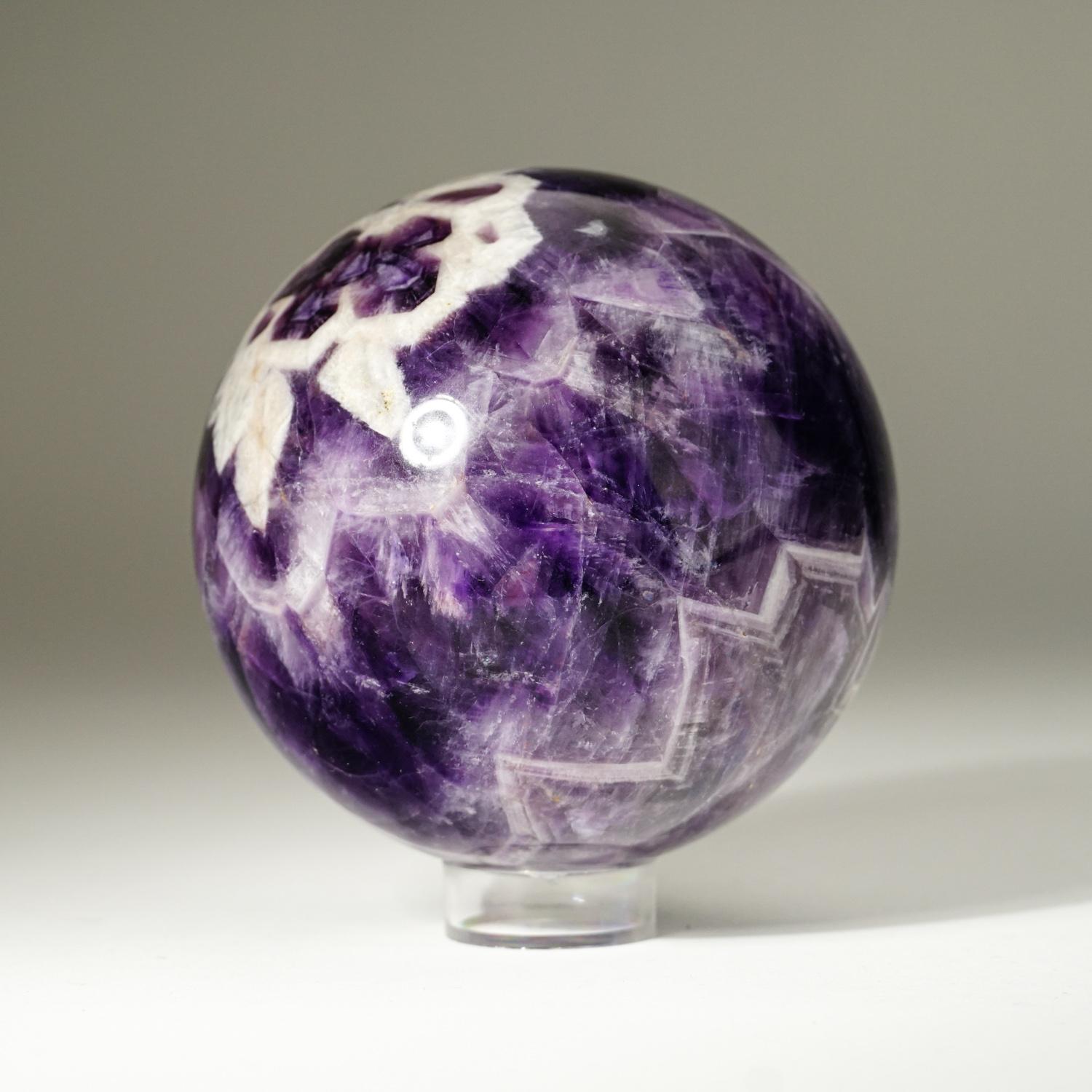 Top quality polished chevron amethyst sphere with vivid purple color and translucent to transparent clarity.
Chevron Amethyst is a combination of Amethyst and White Quartz, mixed together in a V-striped or banded pattern. Chevron Amethyst combines