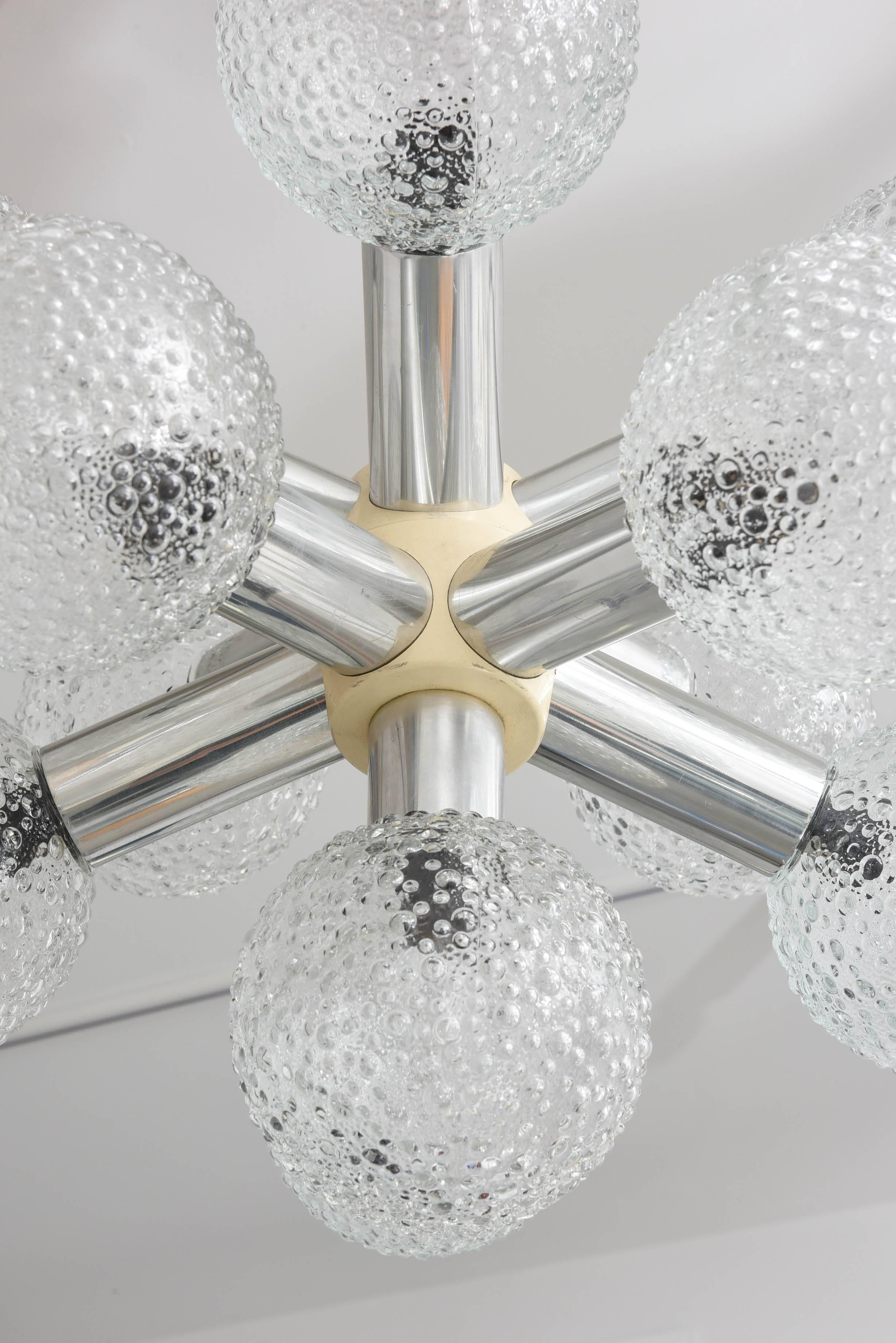 This stylish Mid-Century Modern chandelier dates to the 1960s, and it seems to take its inspiration from a star burst or planetary alignments.

Note: This piece takes eleven Edison based bulbs. 

     